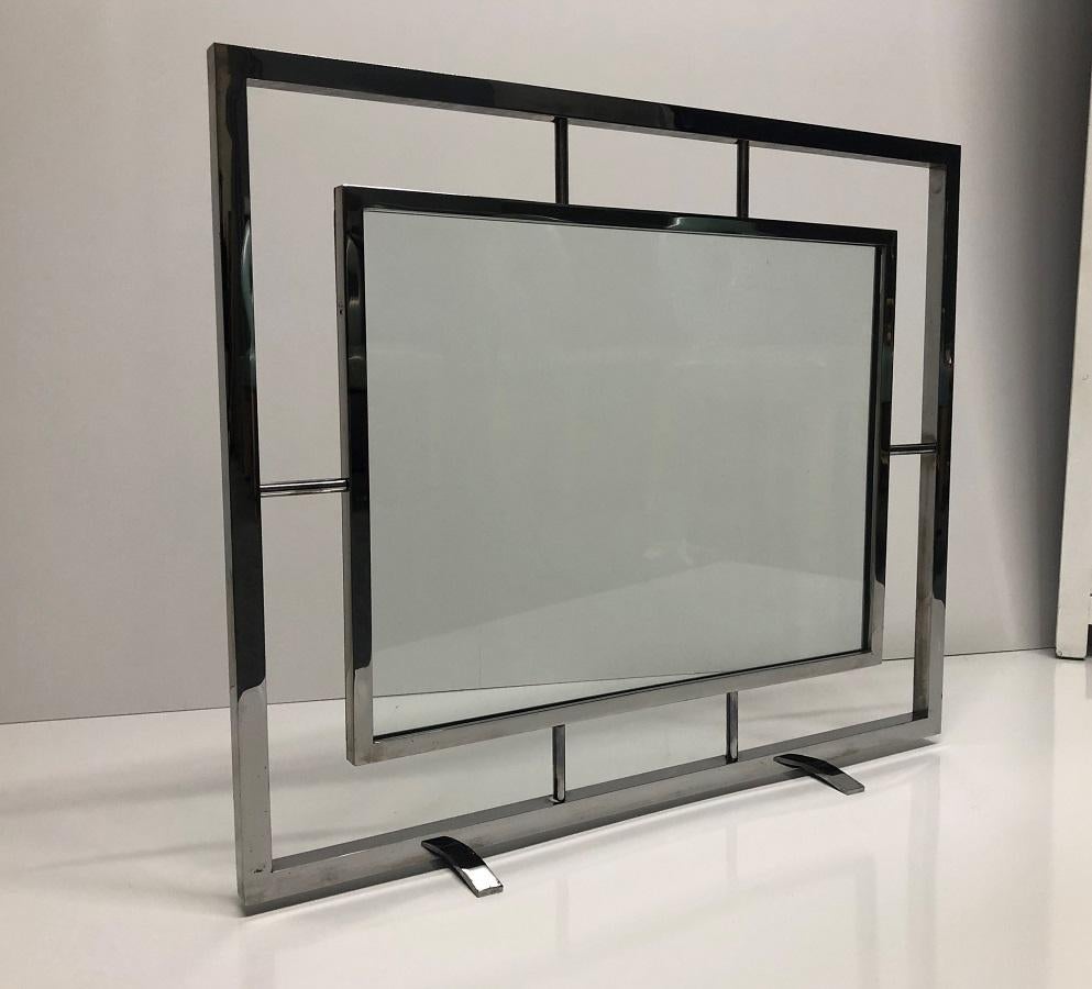 Danny Alessandro chrome and glass fire screen. The center of the screen is glass and the frame is steeled and chrome plated.