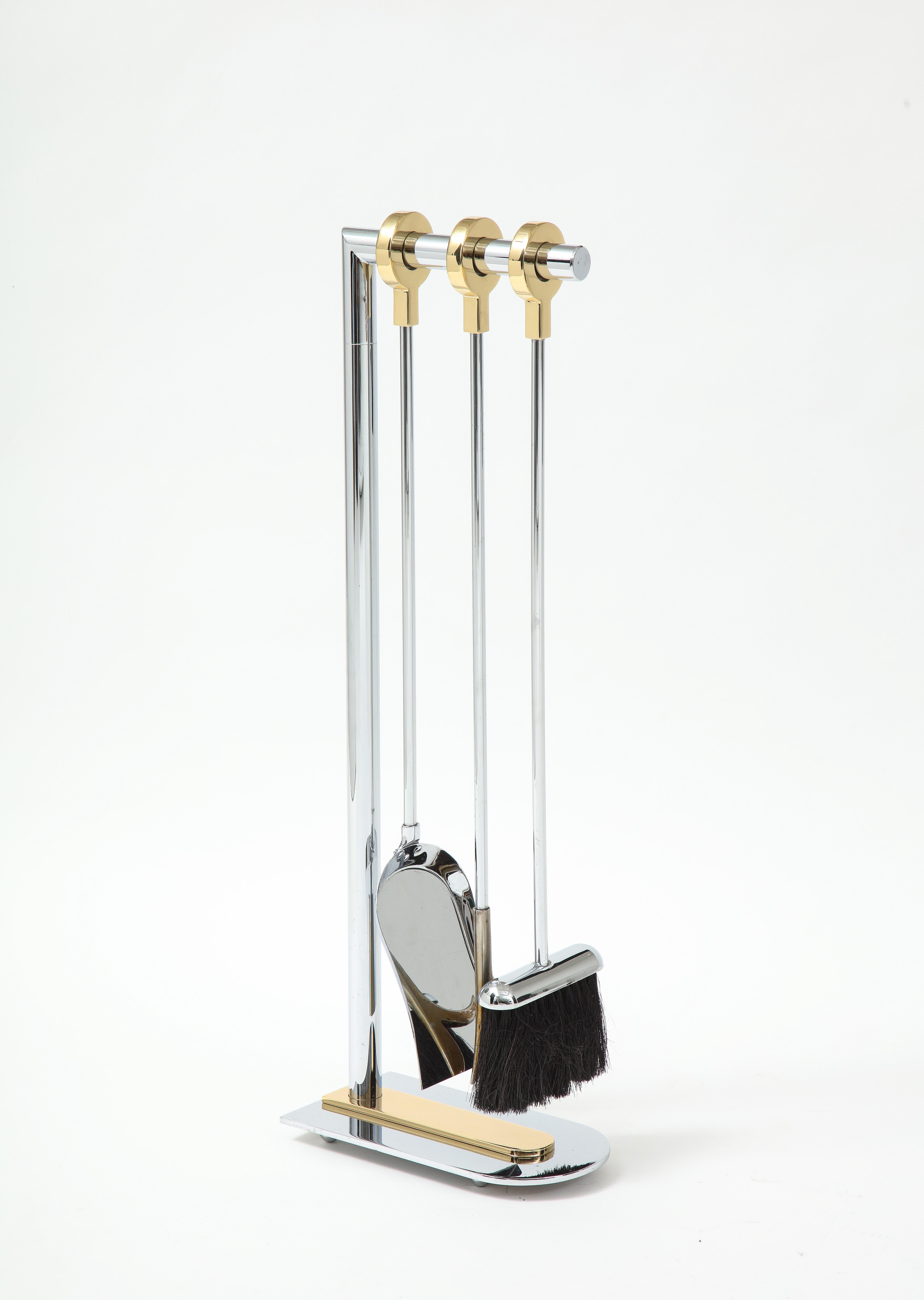 Modernist set of polished steel firetools with open brass ring finials and brass base plate. Professionally polished.