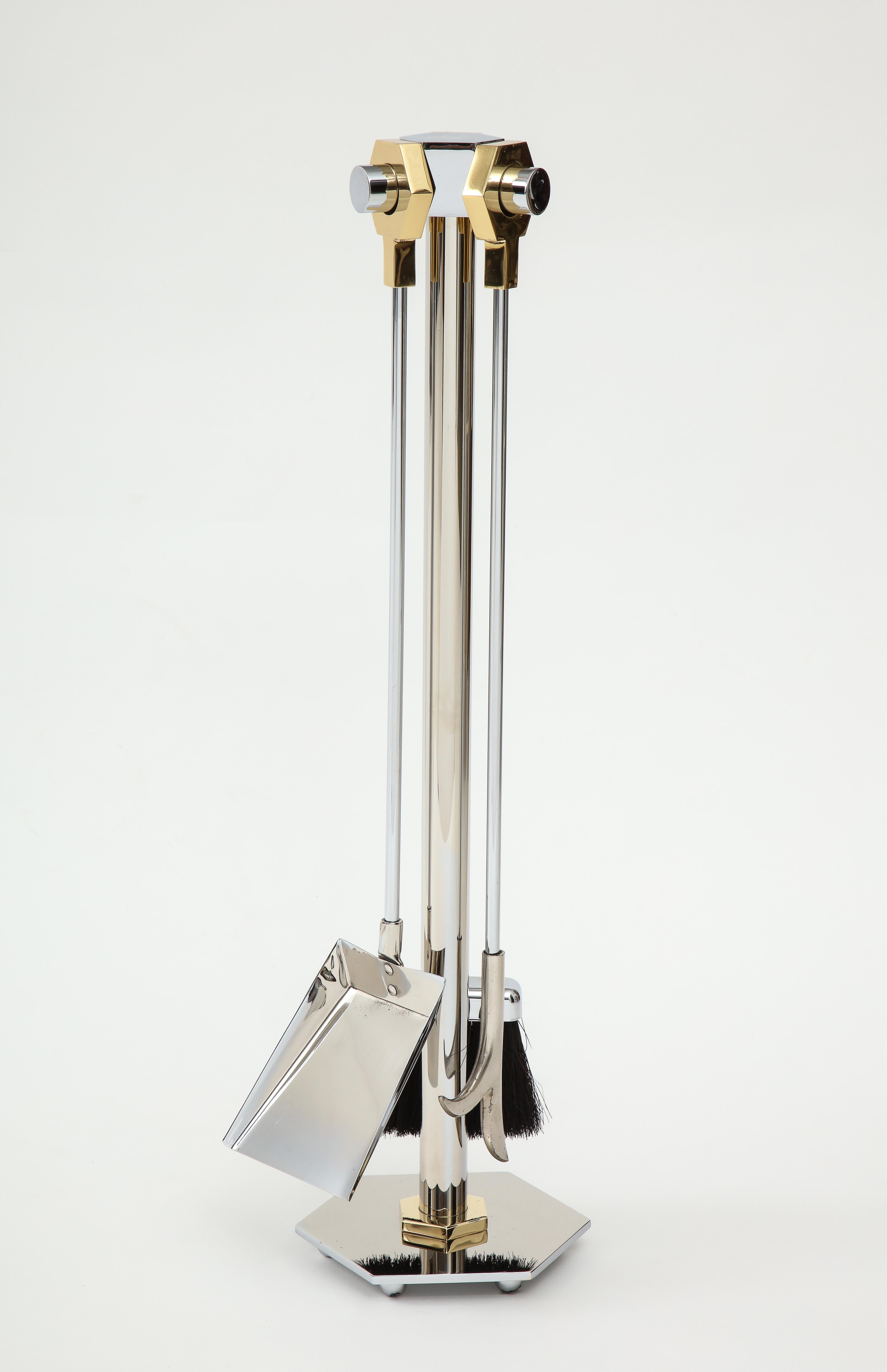 Chic set of polished steel fire tools with polished brass octagonal handles. Set includes poker, shovel, and broom. Mint condition, professionally polished.