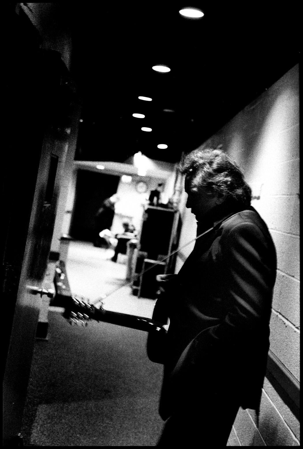 Danny Clinch Black and White Photograph - Johnny Cash Waiting in a Hallway