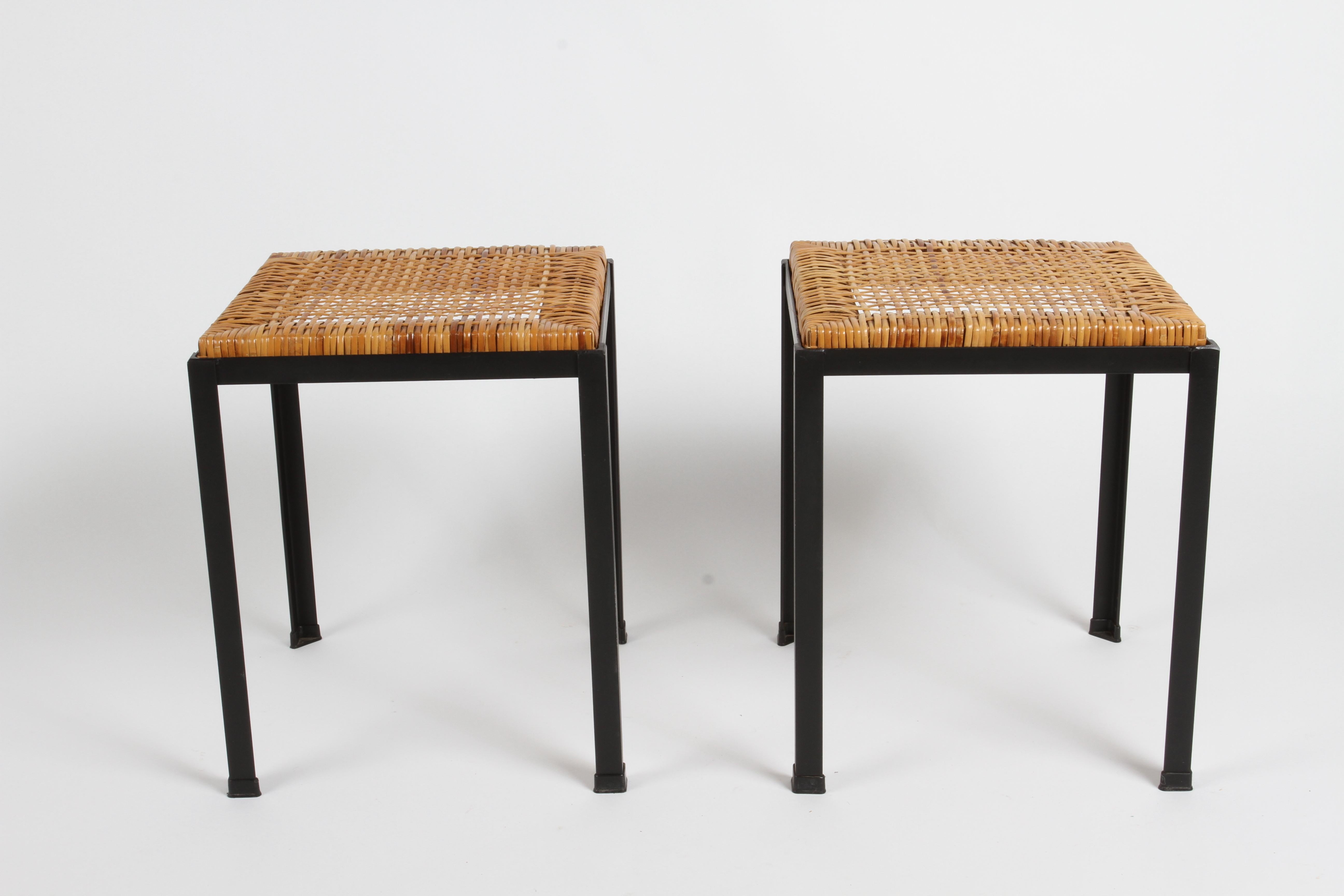 Pair of vintage black iron and handwoven woven cane wicker top stools designed by Danny Ho Fong, from his 1960s Tropical causal California Osetsu Dai Dining Collection. These stools can be used as seating or place a glass top and make them tables.