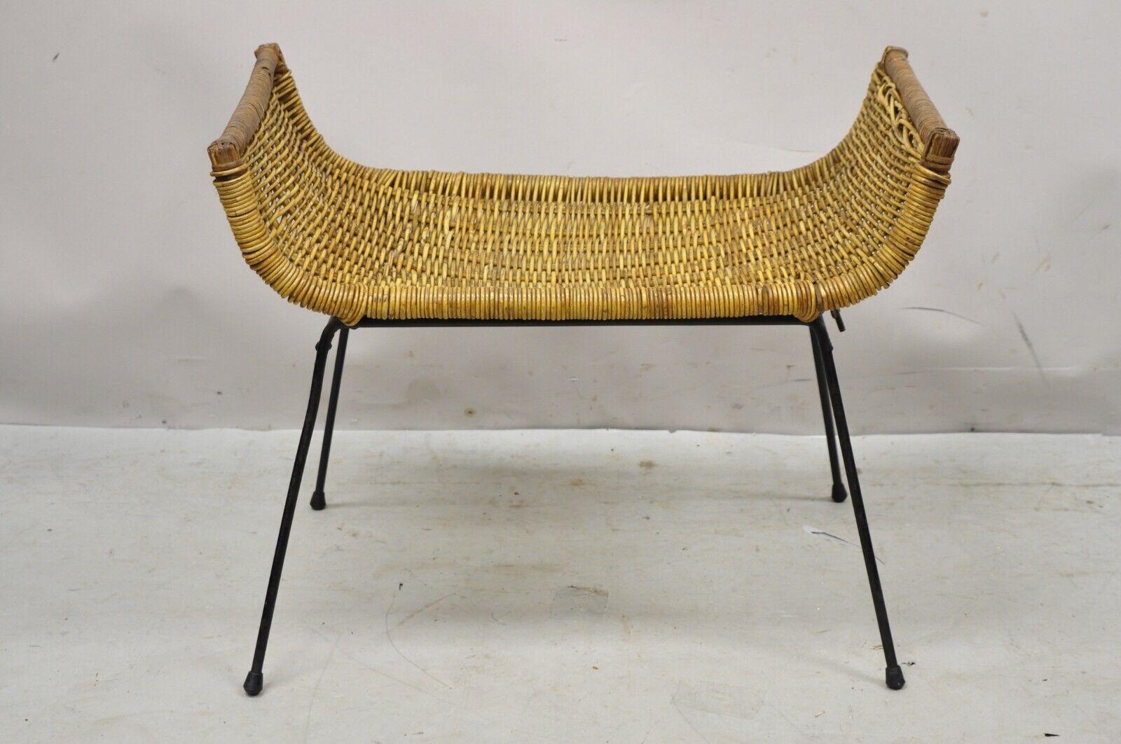 Danny Ho Fong Tropi-Cal rattan and wrought iron mid-century ottoman footstool. Item features wrought Iron base, woven rattan frame, very nice vintage item, clean modernist lines, great style and form, attributed to Danny Ho Fong for Tropi-cal. In