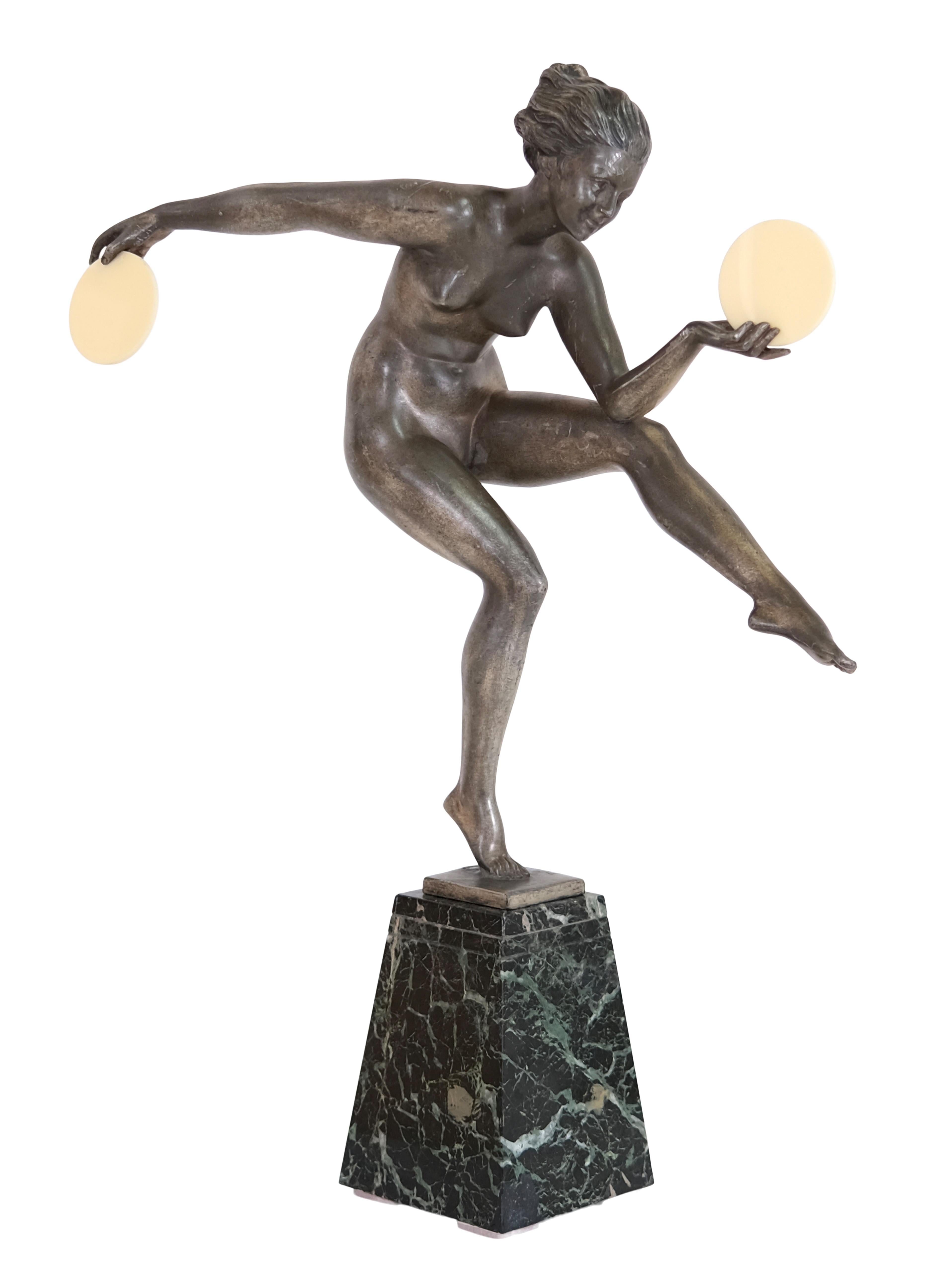 Danse païenne (french for: pagan dance)
Graceful sculpture of a dancer

Design and draft by by Alexandre-Joseph Derenne for Max Le Verrier

White bronze with original patina
Marble base
Discs made of resin

Original Art Deco, France