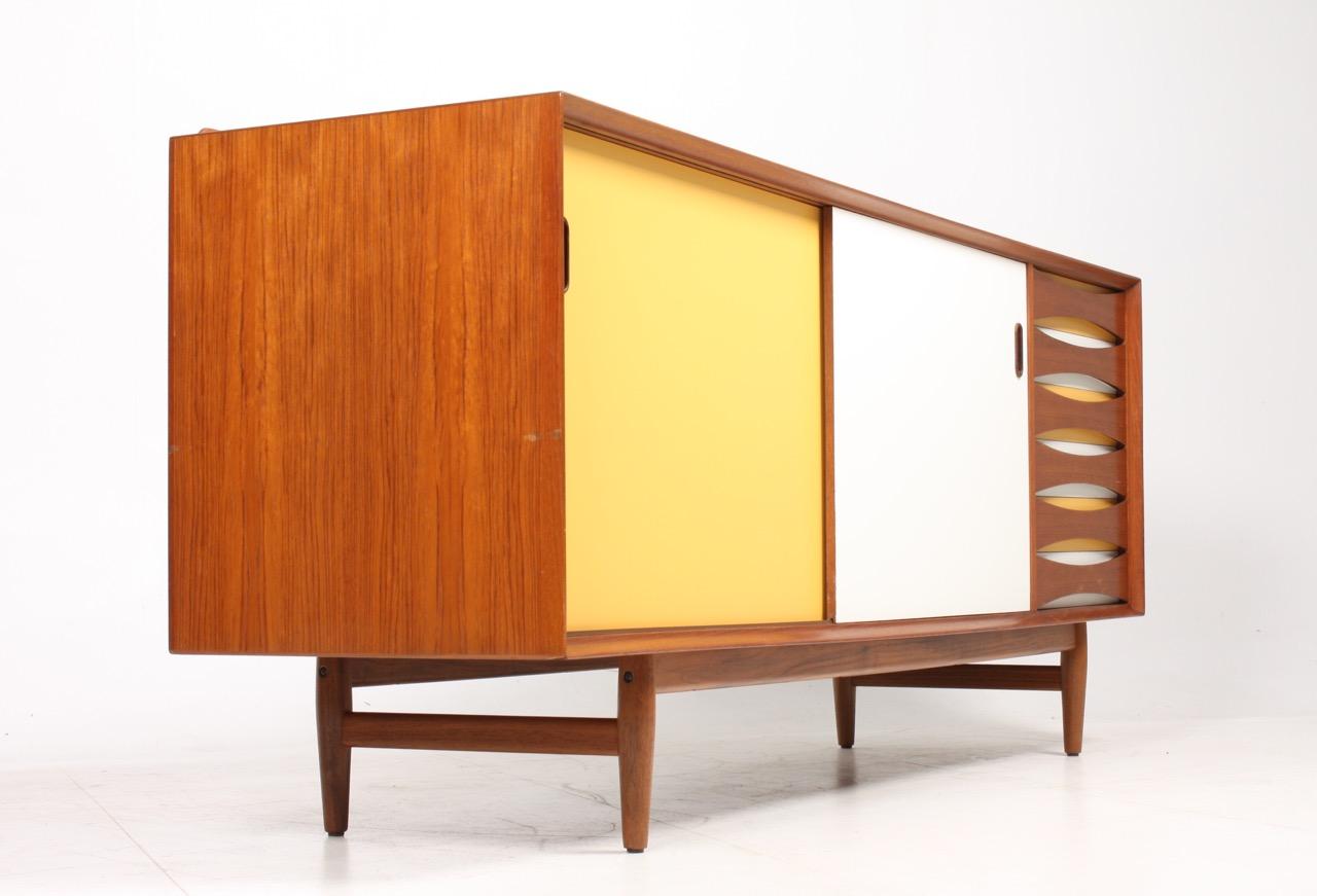 Credenza in teak with colored panels and a bank of six drawers. Designed by Maa. Arne Vodder for Sibast Furniture in the late 1950s. Great original condition.