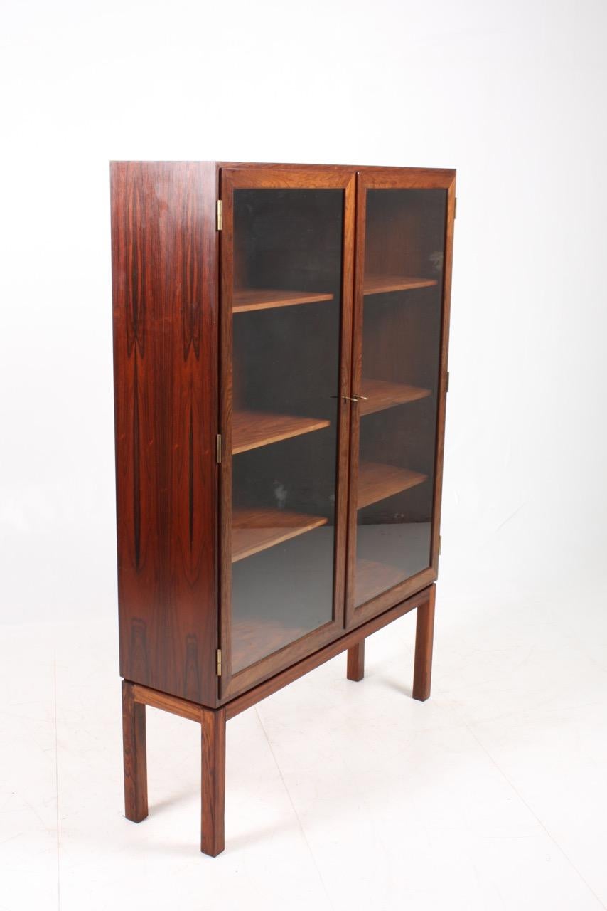 Vitrine in rosewood with double glass doors. Designed and made in Denmark in the 1960s. Great original condition.