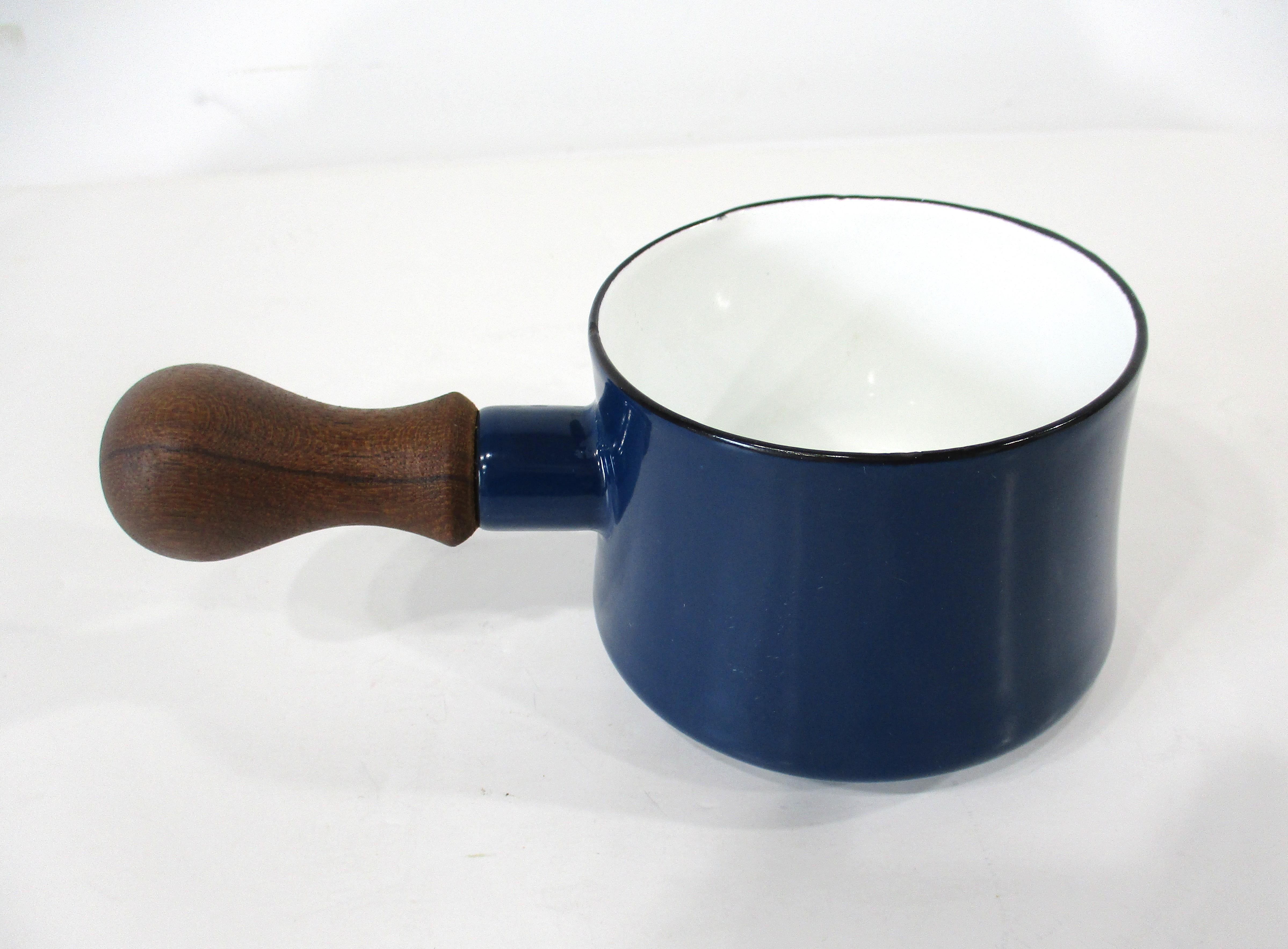 A nice sized Koben styled sauce or melted butter pot with wood handle in a blue with white interior in enameled porcelain . Manufactured by Dansk and designed in 1956 by Jens Quistgaard made in Denmark . 