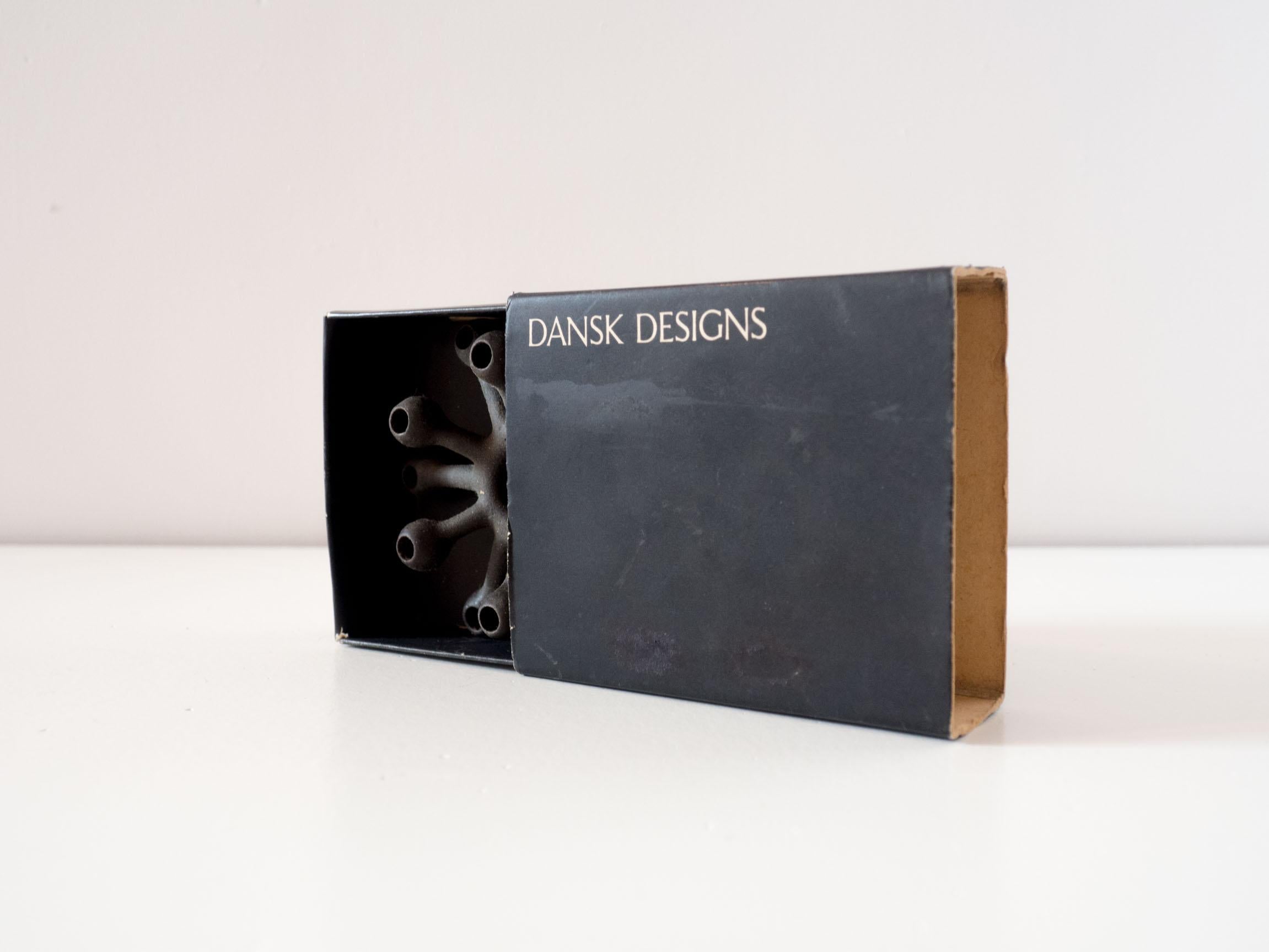 Dansk Designs candle holder – Jens Quistgaard.

This iconic ‘spider’ candle holder is made of cast iron. It supports slim candles that can also be found on the website.

The original box is still with the candle holder, making it a perfect present