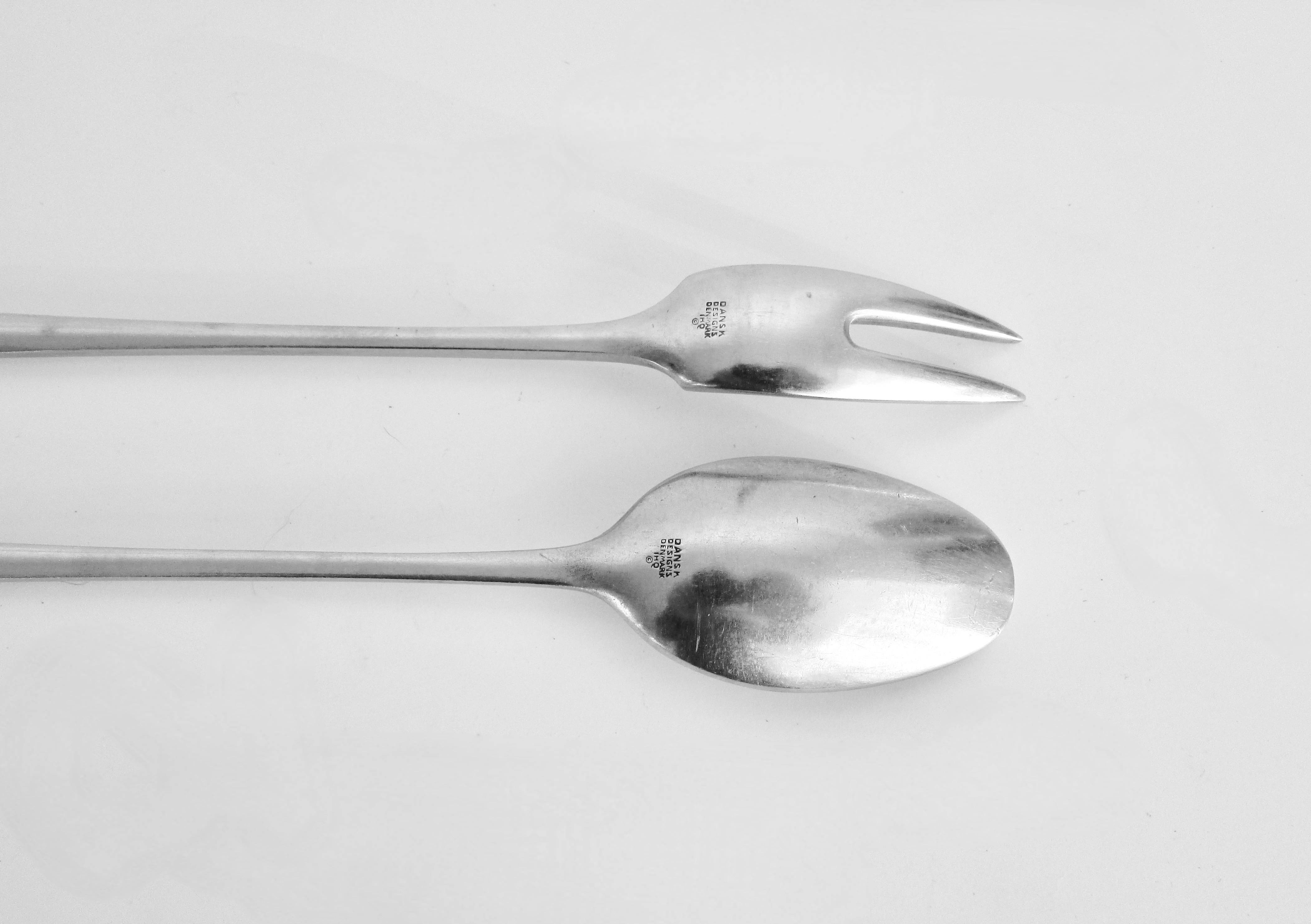 Early Dansk production cocktail pieces . Long stir spoon and olive fork . Both marked Dansk Designs Denmark JHQ and copyright 