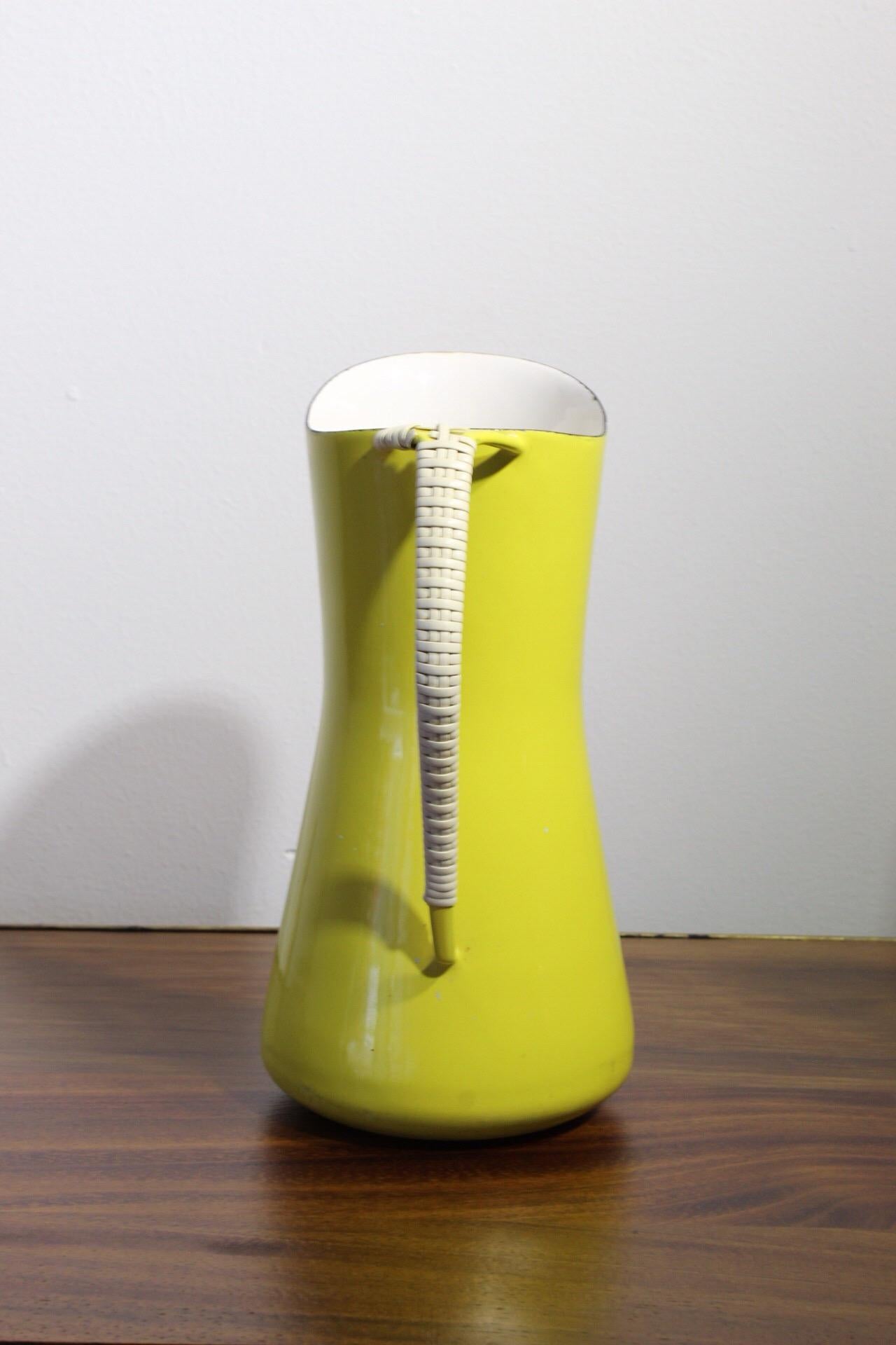 Dansk designs Denmark yellow enamel pitcher with rattan wrapped handle.
More photographs available on request, let me know if you have any questions.