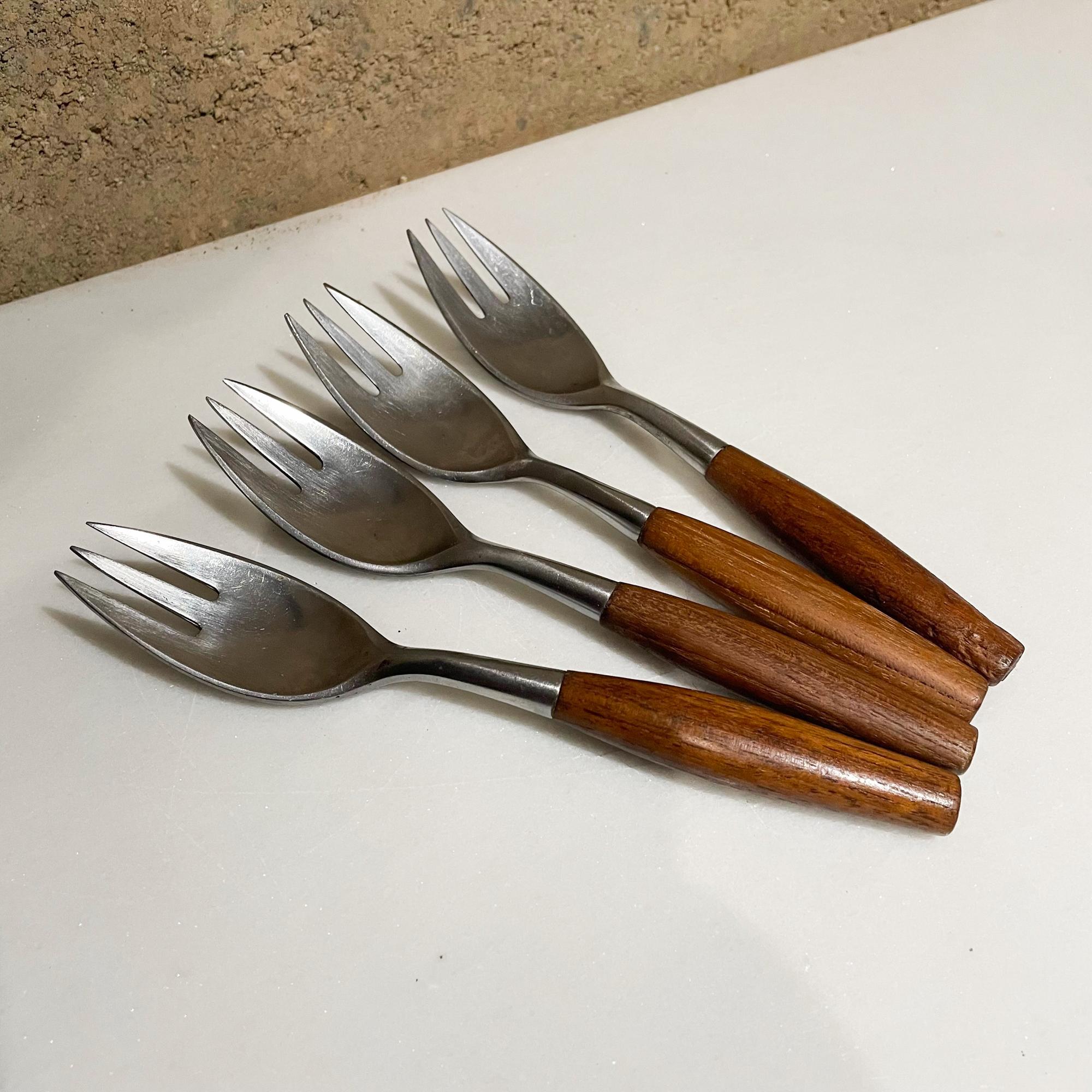 Set of Four Salad Forks
Dansk IHQ Fjord Designs from Germany by Jens Quistgaard designed in 1954
Maker stamped.
Designed in Teak Wood and Stainless Steel.
6.5 x 1.13 x .88 inches.
Original unrestored preowned use vintage condition. 
See our images