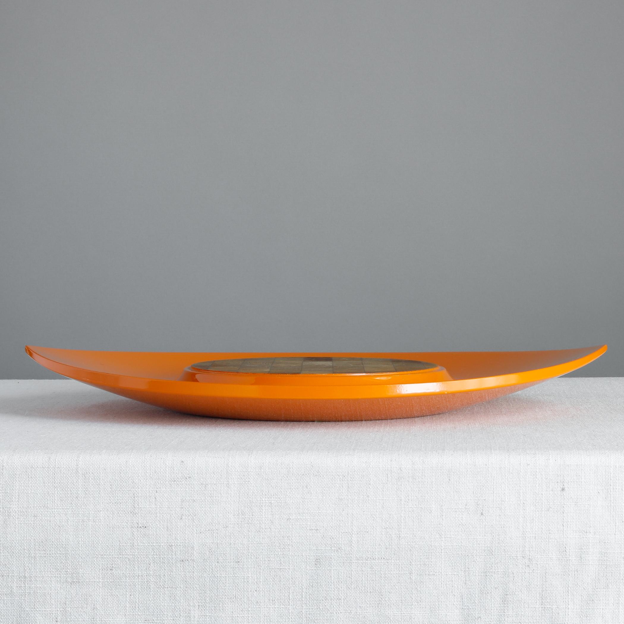 Orange lacquered wood 'Festivaal' serving tray designed by Jens Quistgaard for Dansk. Called an 'endwood tray' in Dansk catalogues, the center is made of teak and used for cutting cheese or other treats--crackers can go around the perimeter. The