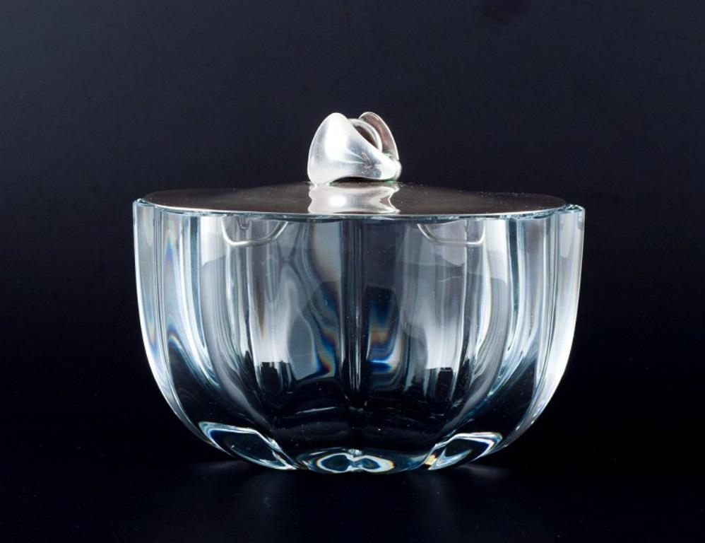 Dansk Guldsmede-Håndværk (1954-1973)
Danish design. Art glass jar with a lid in sterling silver. 
Modernist and sleek design.
Around the 1960s.
In perfect condition.
The lid is stamped DGH, Sterling, Denmark, 925S.
Dimensions: L 13.0 cm x W 9.5 cm x