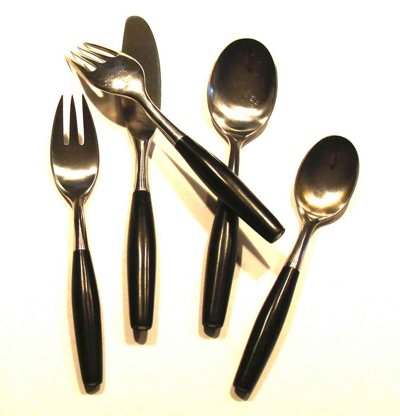 Service for four. (More available). Beautiful vintage five-piece place setting of Kongo flatware featuring 
stainless steel with ebony nylon handles (dishwasher safe). Crafted in Germany circa 1958. Showing gentle wear. 
 No damage.
Setting