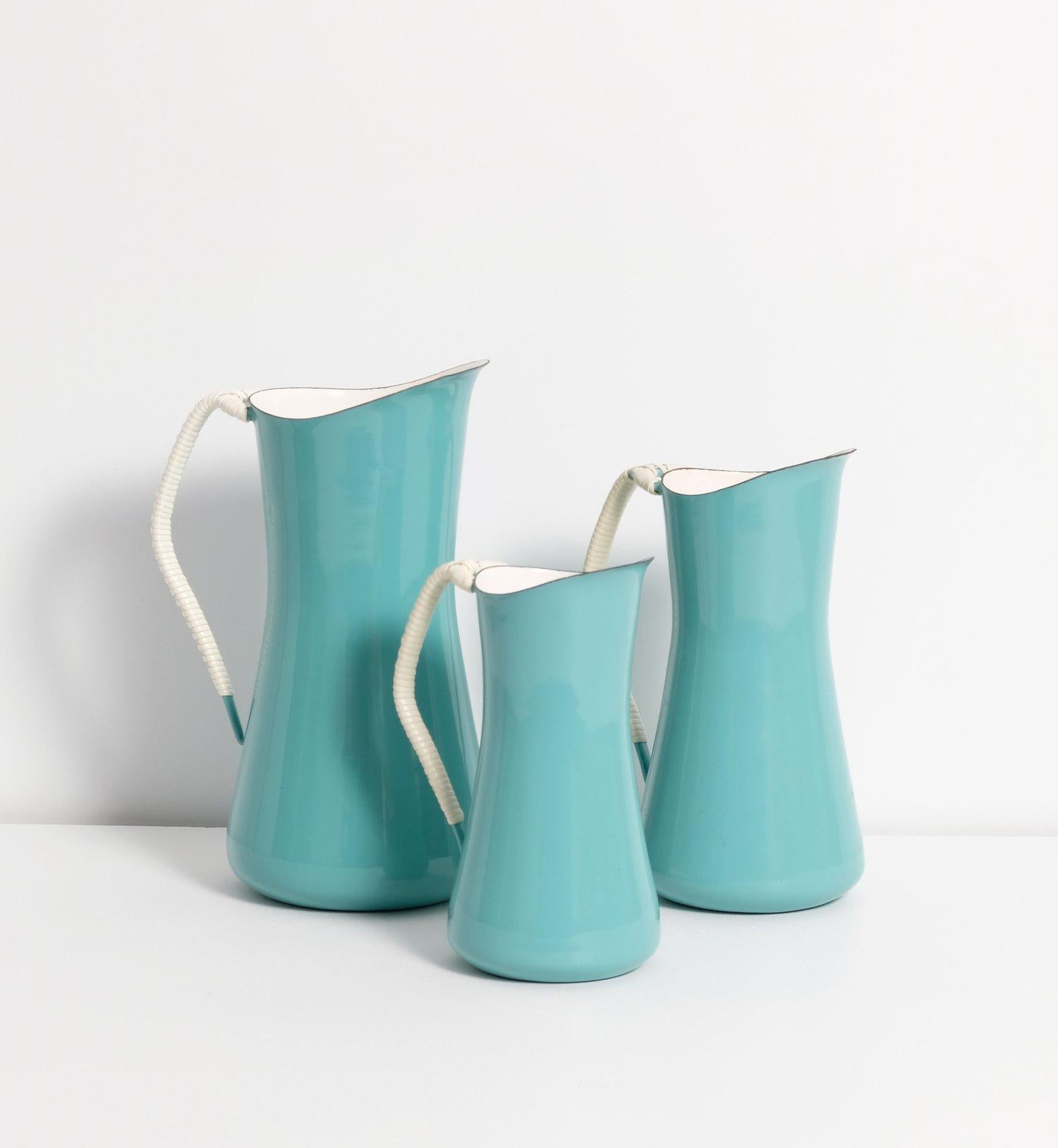 Near mint set of three Dansk Kobenstyle IHQ turquoise/teal pitchers designed by Jens Quistgaard, 1956, early 4 ducks logo produced in Denmark.

Large pitcher: 10.5” high x 5.5 wide

Medium pitcher: 9” high x 5” wide

Small pitcher: 8” high x 4.5”
