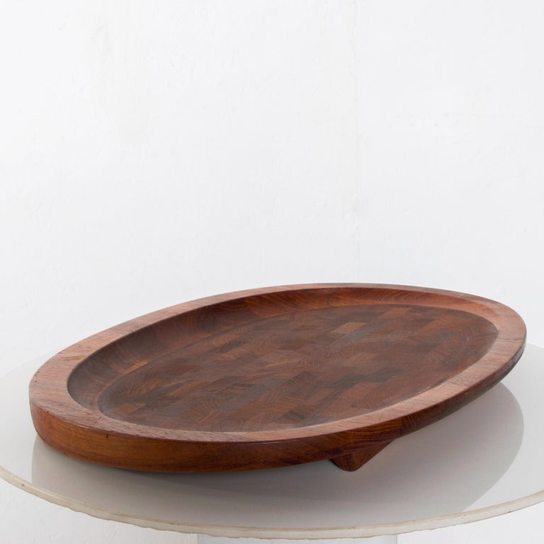 AMBIANIC presents:
Dansk IHQ Large Checkerboard meat carving cutting board tray serving platter  mosaic of staved solid teak by designer Jens Quistgaard, Denmark 1965.
Modern vintage solid & heavy piece, angled foot base, ideal for