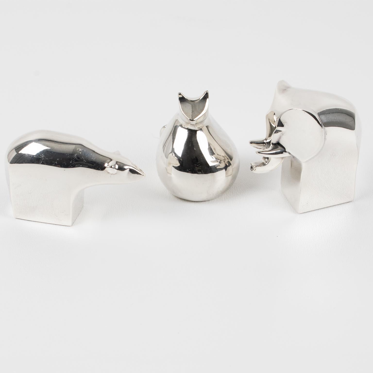 These decorative Scandinavian Mid-Century animal sculptures were created exclusively for Dansk Design in the early 1970s by world-renowned Swedish designer Gunnar Cyren. This gorgeous modernist set of three silver-plated figurines of a cat, an