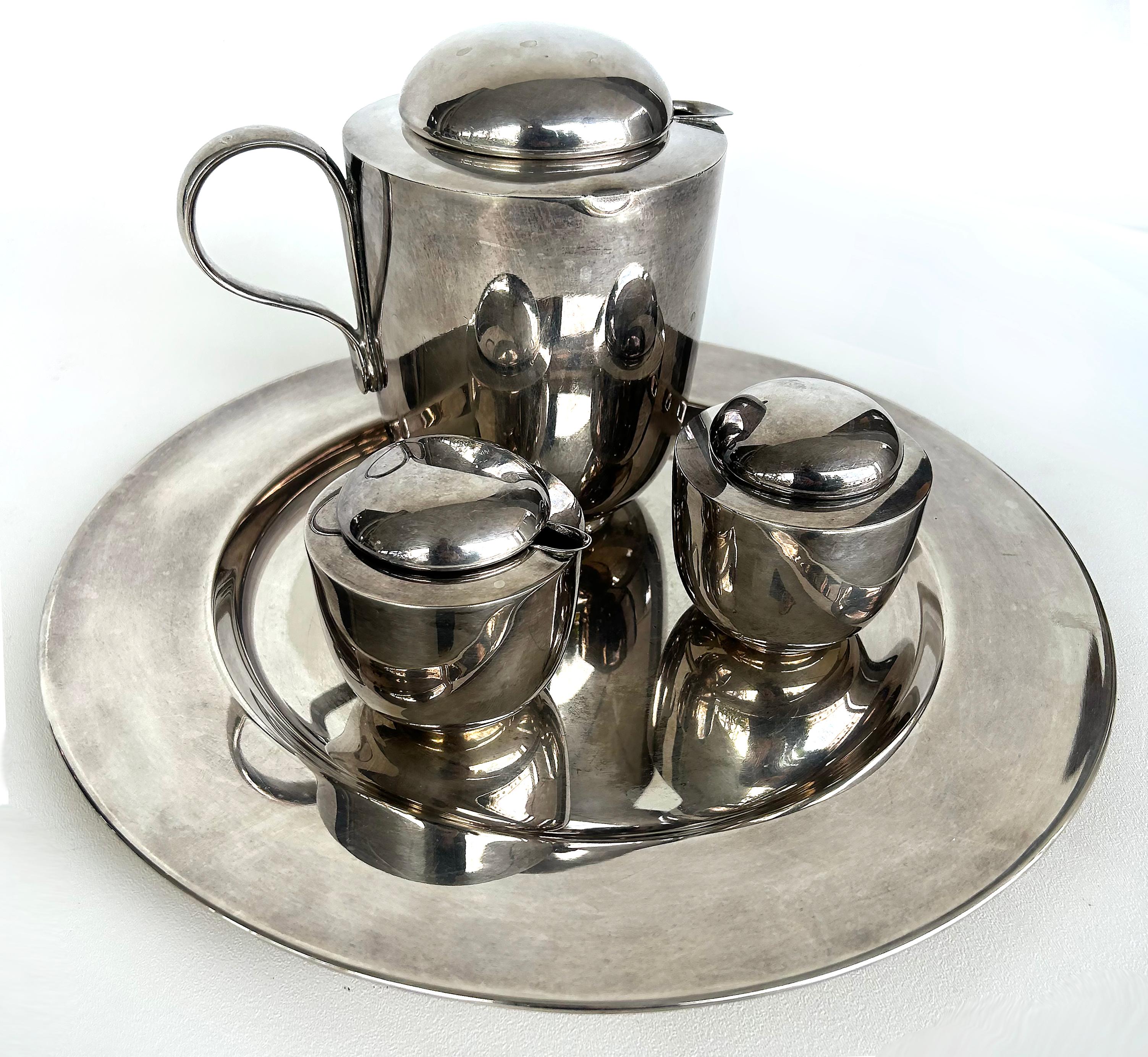 Dansk Silver-Plated Brass Tea Set Designed by V. Lorenzo Porcelli

Offered for sale is a silver-plate on brass tea set designed by V. Lorenzo Porcelli (American, b. 1933) for Dansk in the early 1980s at the height of the Memphis era. This design