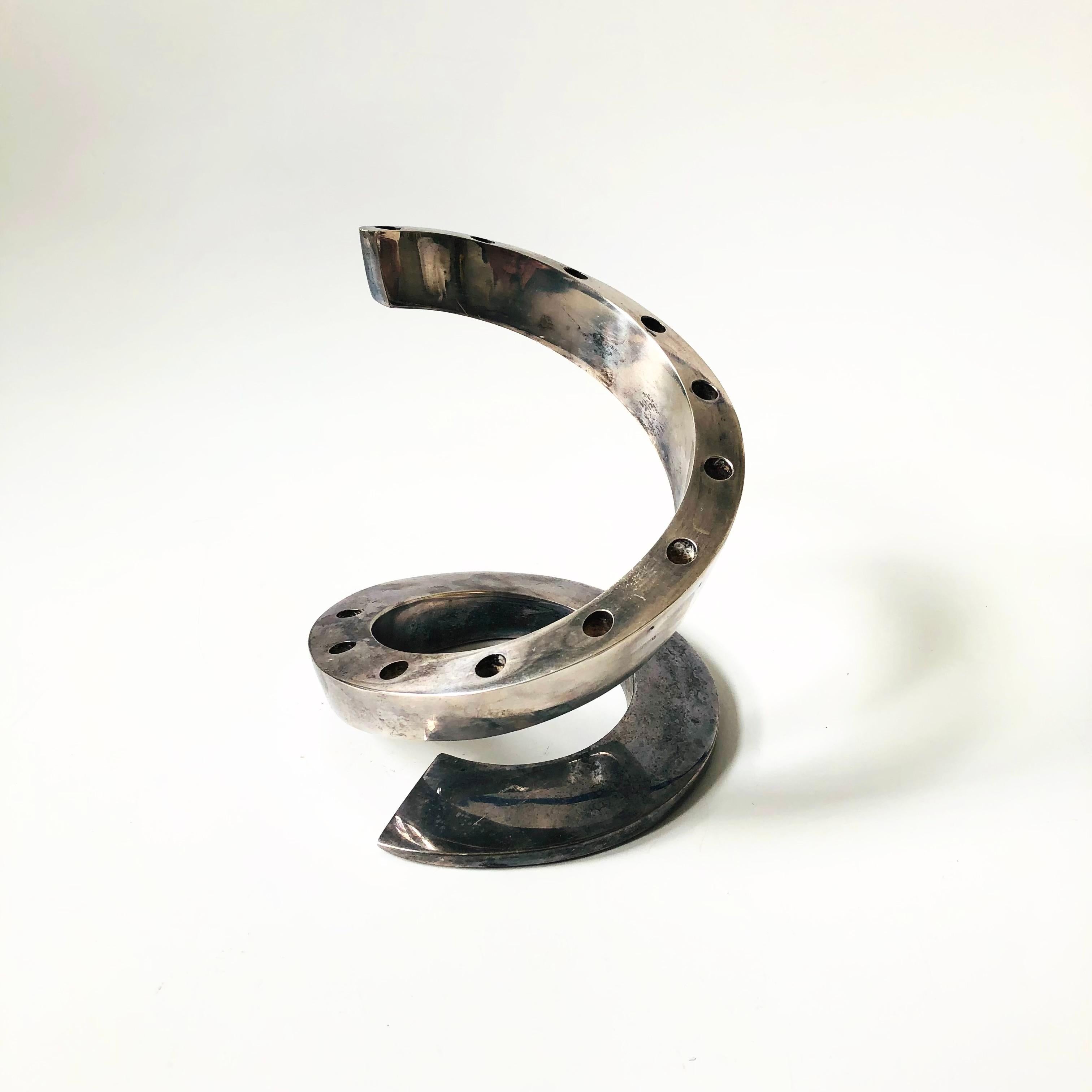 A mid century silver plate candle holder designed by Bertil Vallien for Dansk. Great sculptural spiral shape, holding up to 12 tiny taper candles. Marked 