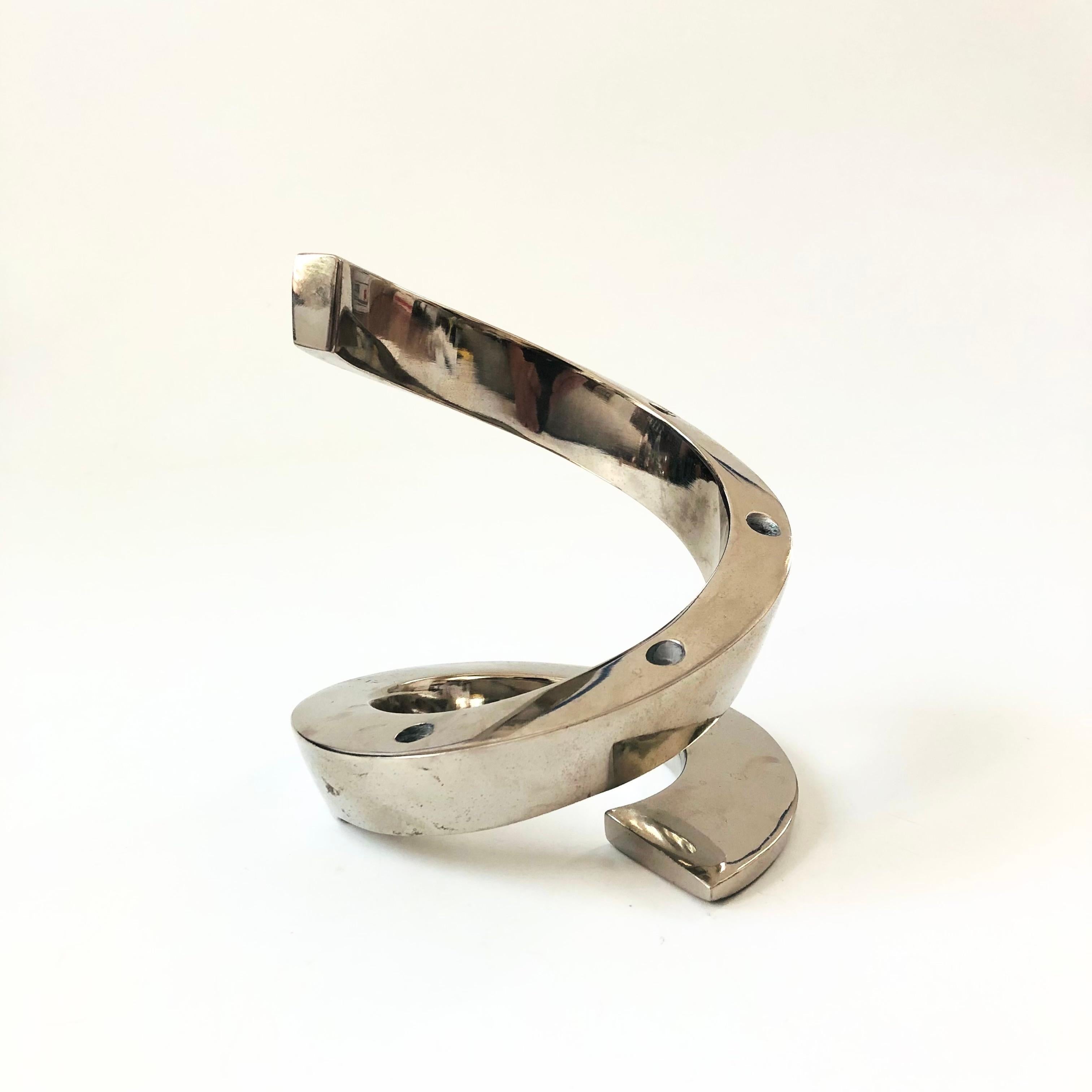 A mid century silver plate candle holder designed by Jens Quistgaard for Dansk. Great sculptural spiral shape, holding up to 6 tiny taper candles. Marked 