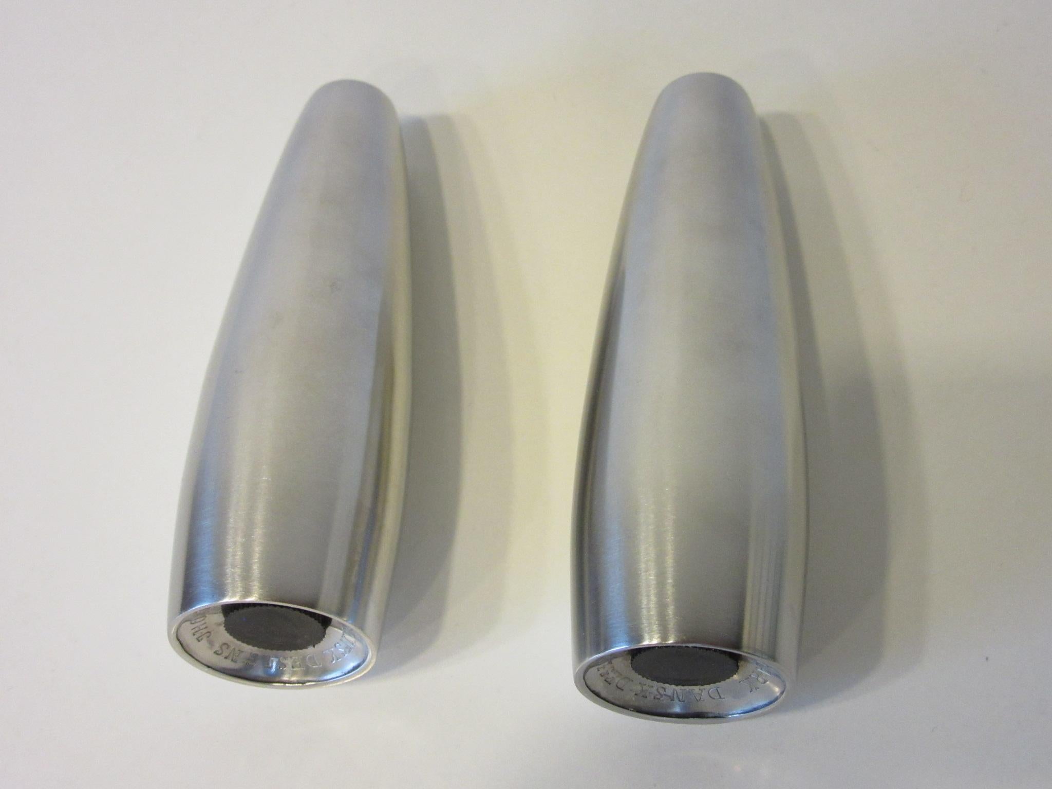 A pair of tapered stainless steel salt and pepper shakers by designer Jens Quistgaard stamped to the bottom Dansk Designs JHQ Denmark.