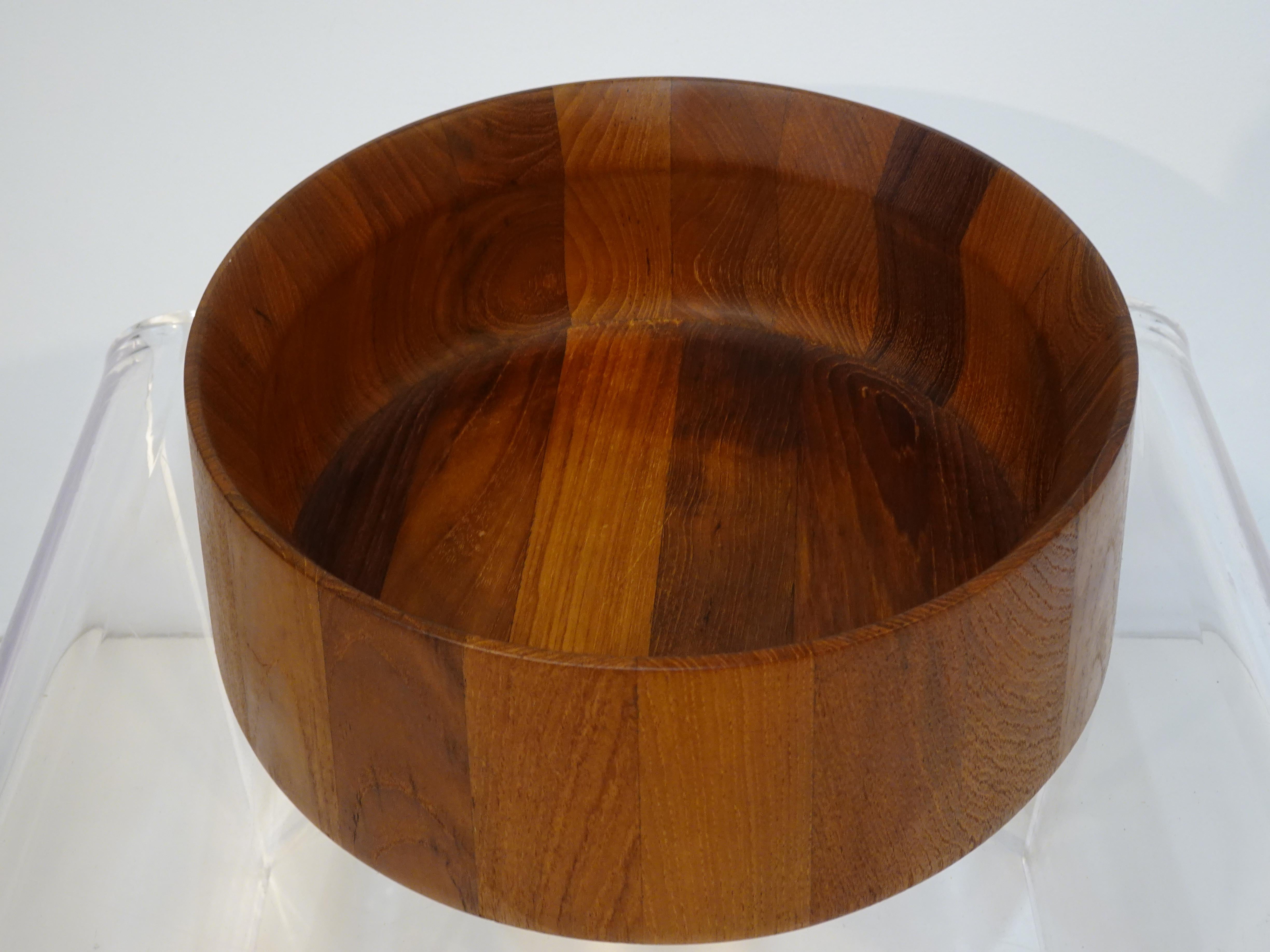 A teak serving bowl designed by the iconic designer Jens H. Quistgaard who's organic pieces including pepper mills, serving pieces and furniture were both practical and beautiful . The manufactures branded mark is to the bottom of the bowl Dansk
