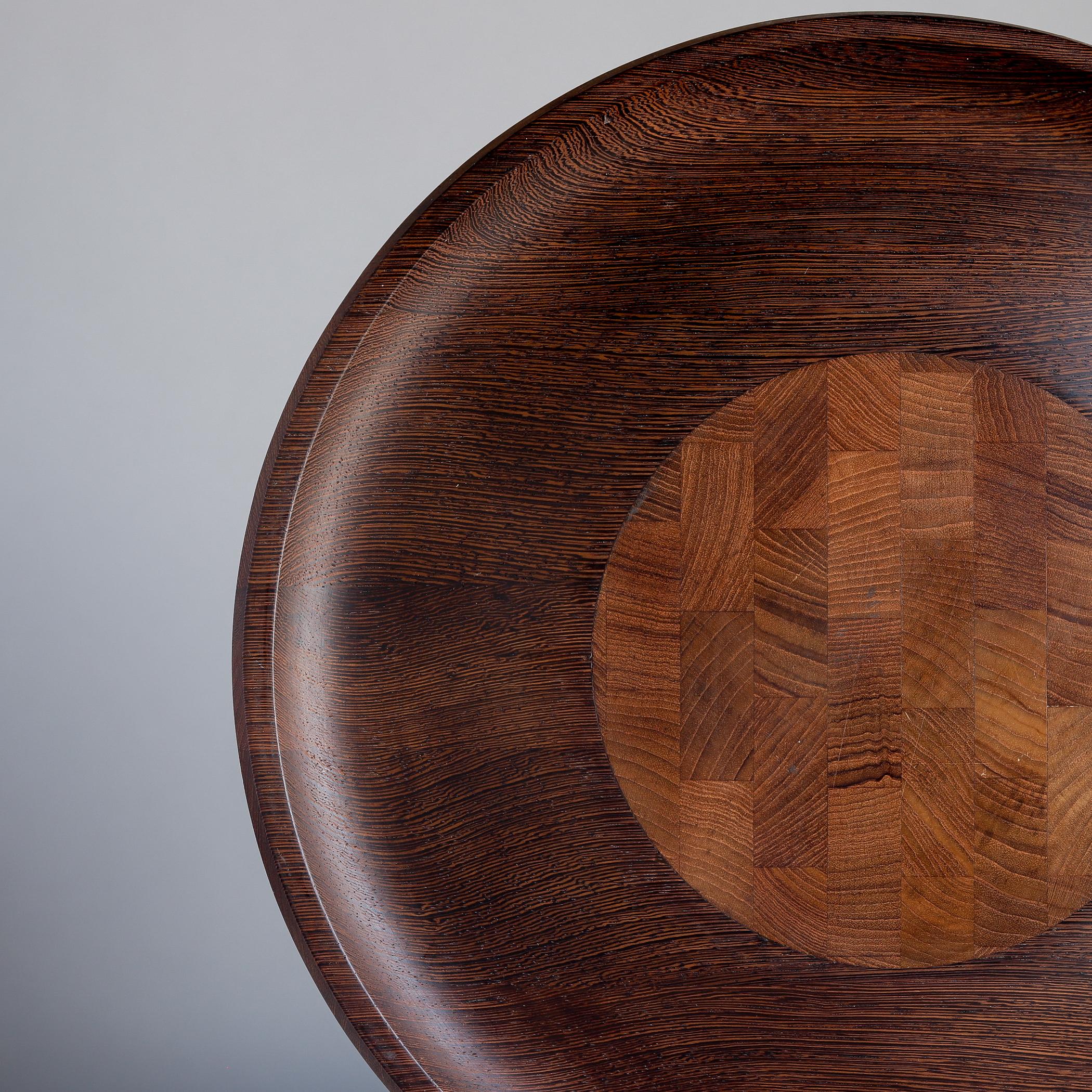 Large circular cutting board and serving tray designed by Jens Quistgaard for Dansk, made in wenge (an African hardwood) for the Rare Woods line produced in the early 1960s, model 1602. The staved end-grain center section (end-grain is hard, durable