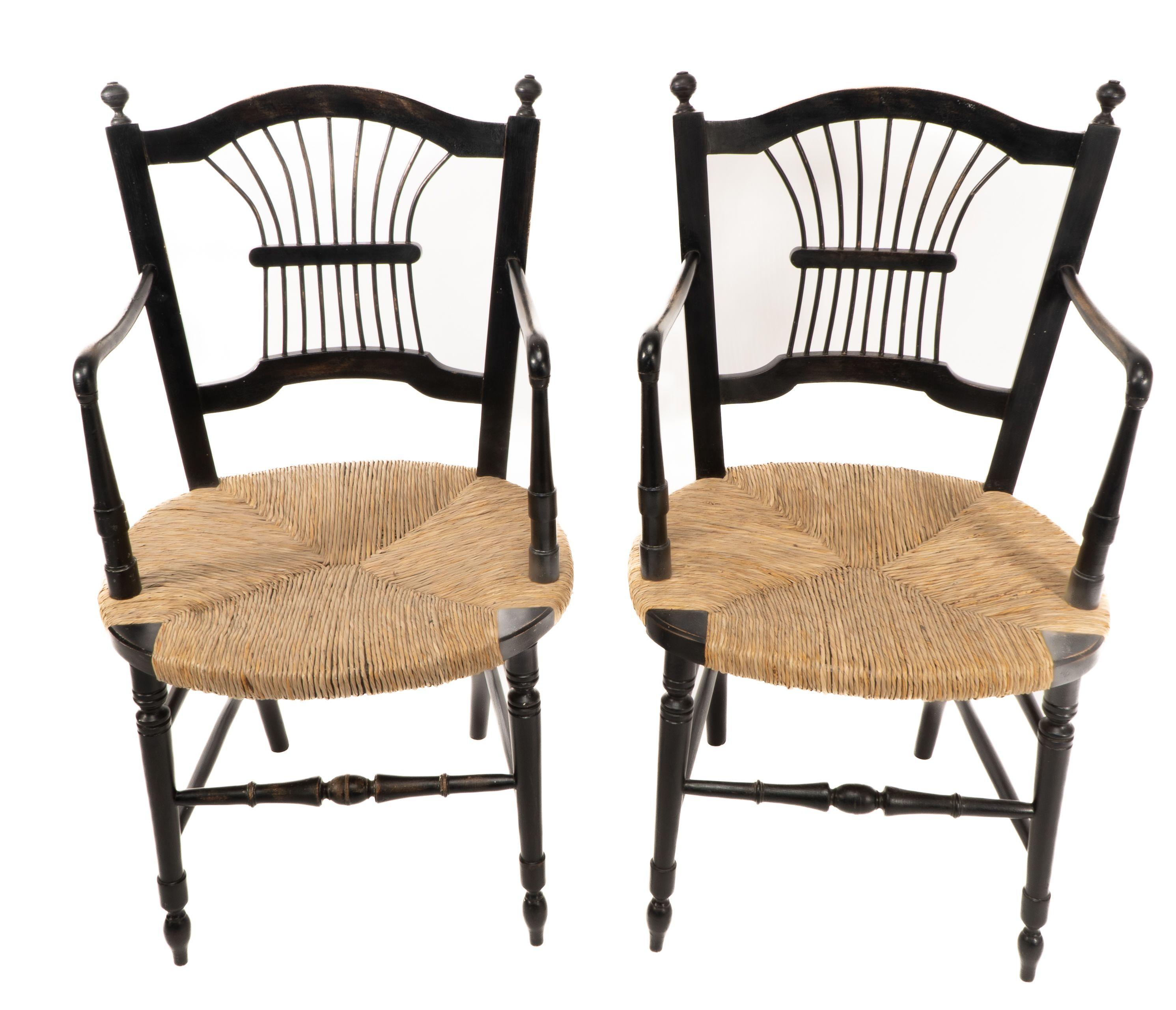 A pair of Morris and Co rush seated armchairs, designed by Dante Gabriel Rossetti with newly laid rush seats.