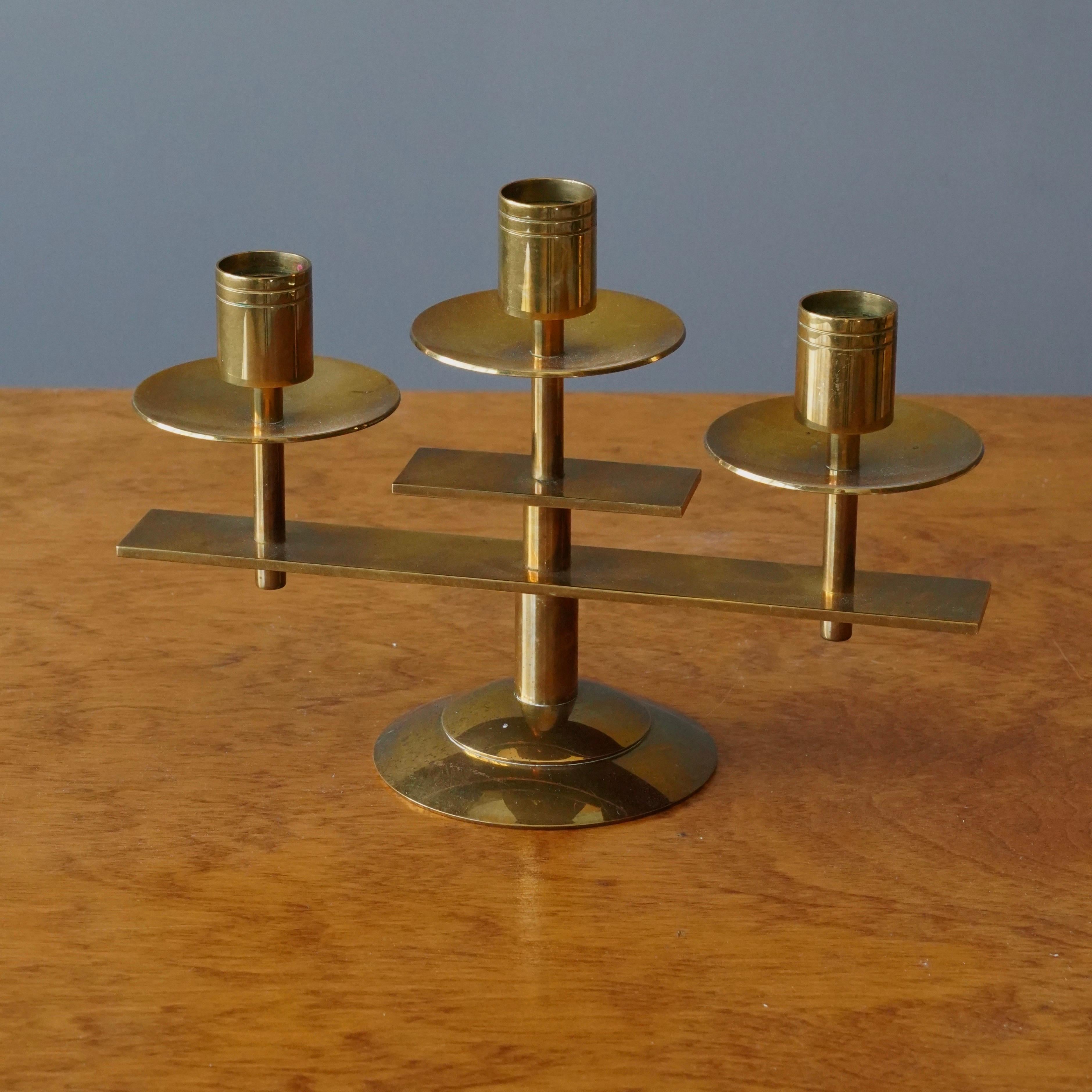 A Candelabra. Designed and produced by Dantorp, Denmark, 1960s. In brass.
