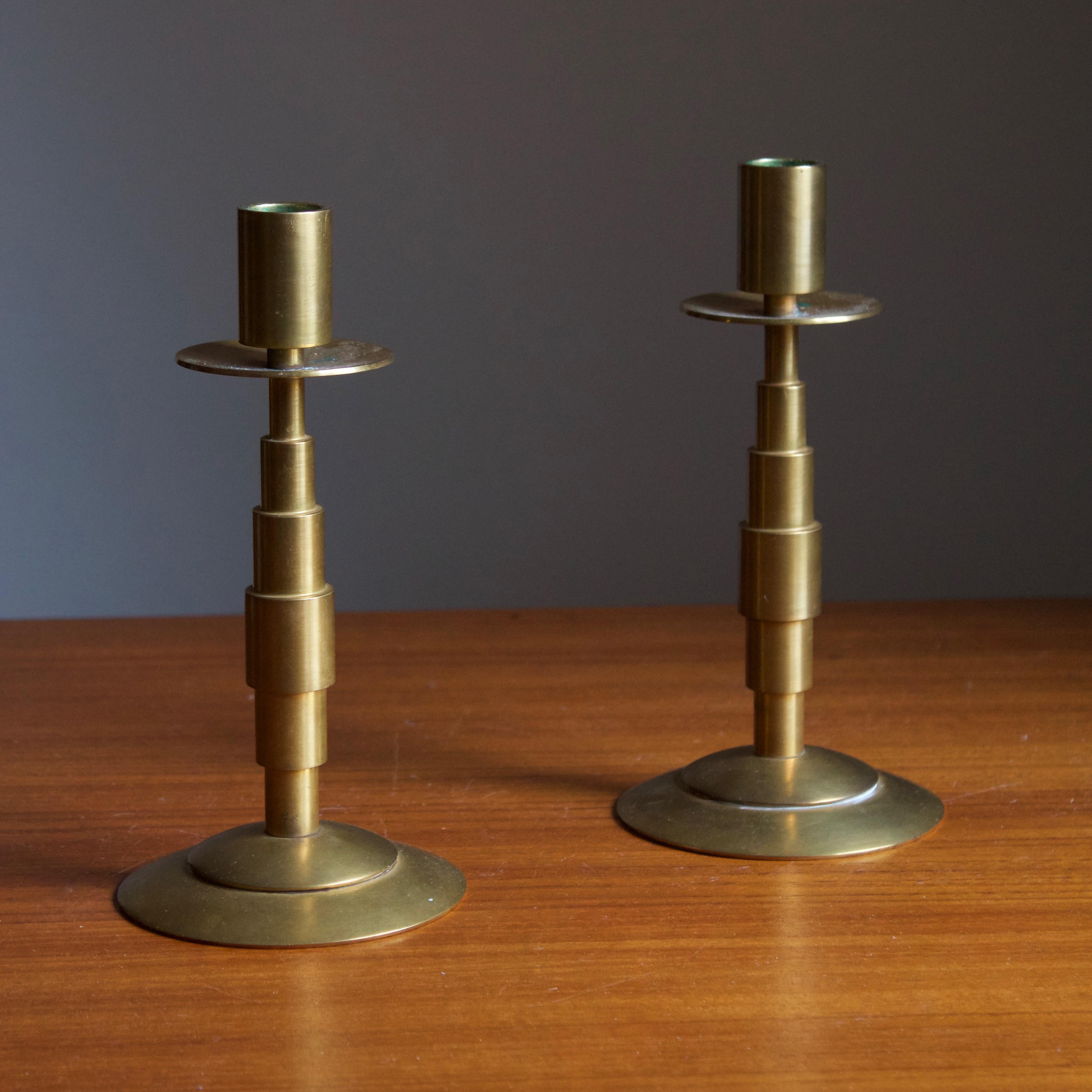 A pair of modernist candlesticks. Designed and produced by Dantorp, Denmark, 1960s. In brass.