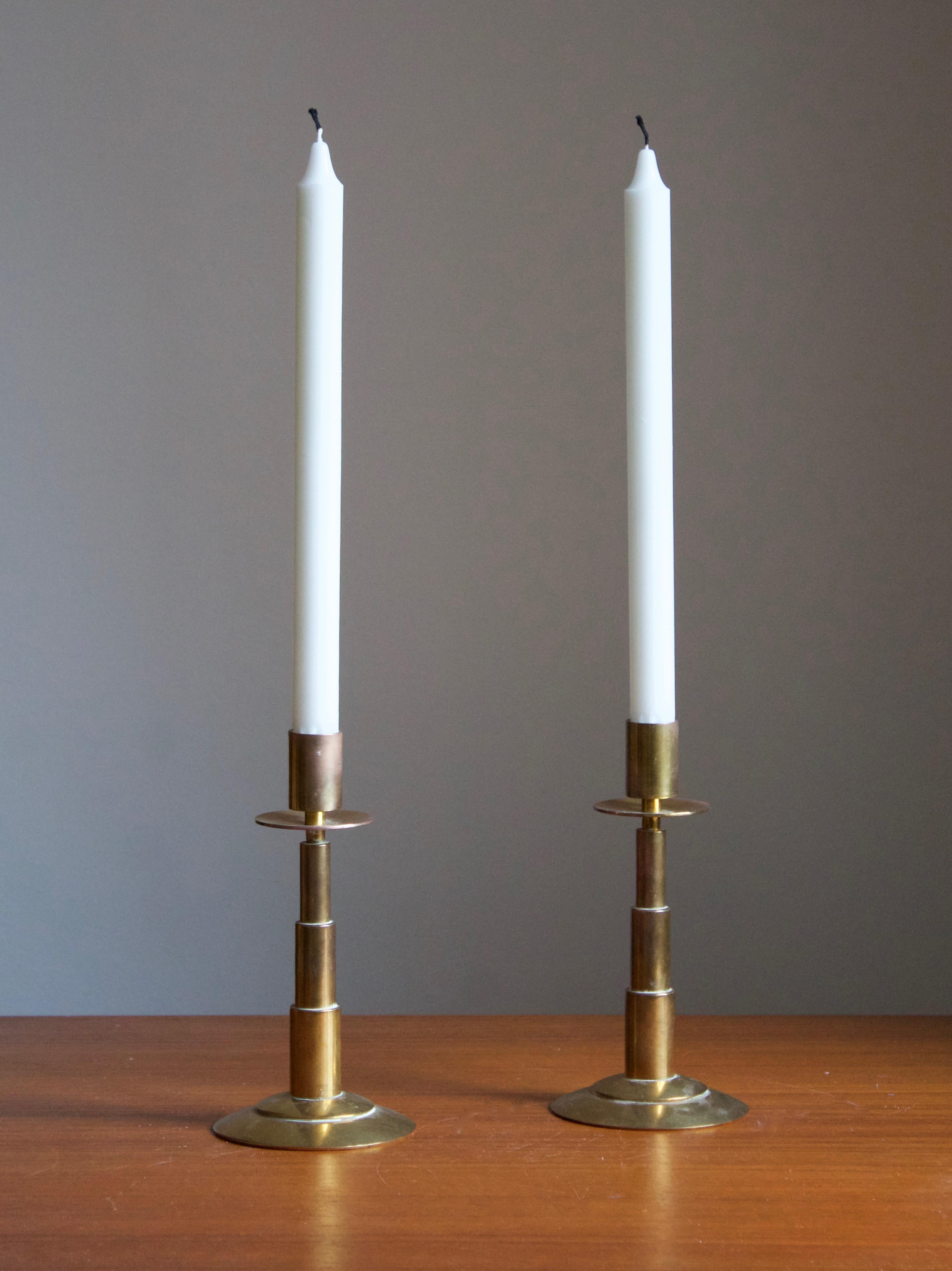 A pair of modernist candlesticks. Designed and produced by Dantorp, Denmark, 1960s. In brass.