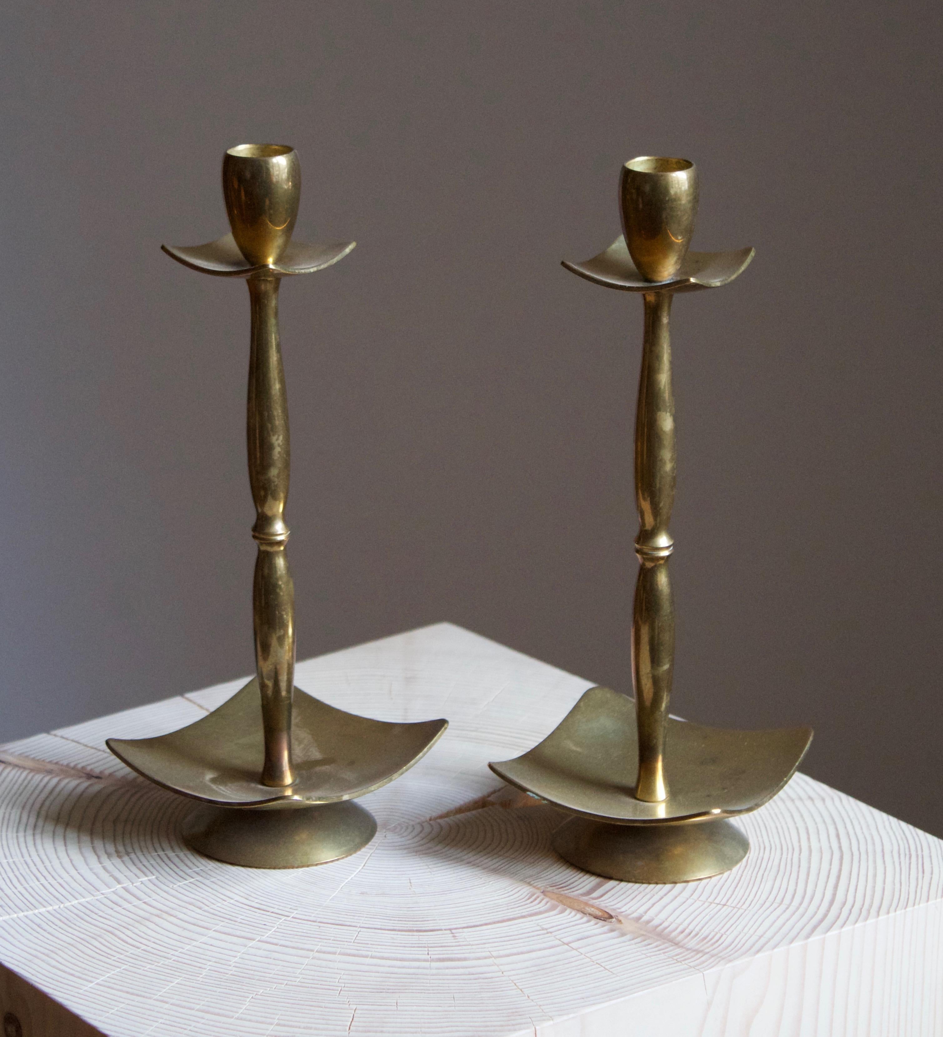 A pair of modernist candlesticks. Designed and produced by Dantorp, Denmark, 1960s. In brass.