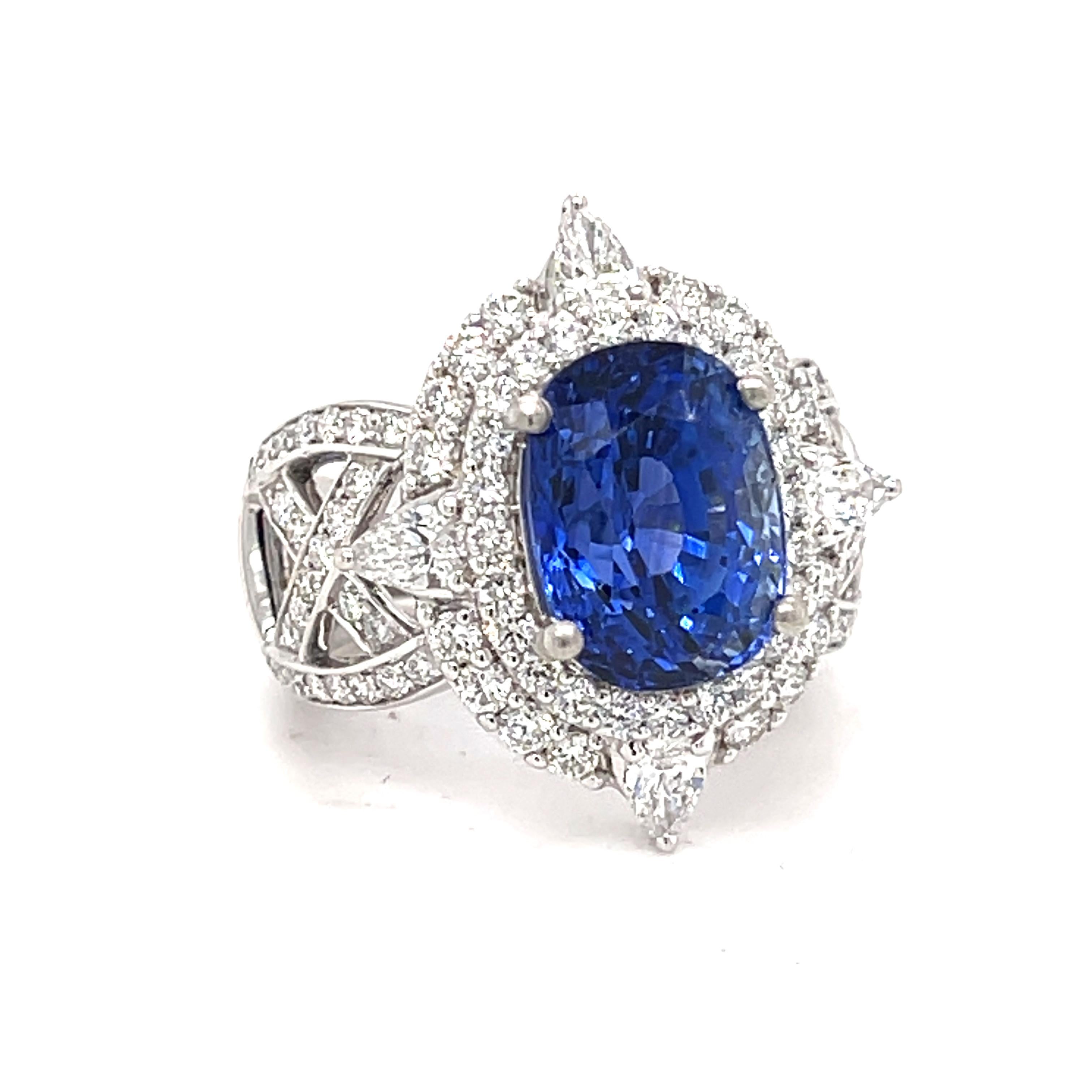 Danuta Regal Platinum Engagement one of the kind ring set with 7.5 carat oval cornflower blue color  sapphire stunning  one of the kind design and surrounded with 2.80 carat brilliant cut diamonds FG color VVS1 clarity. This assessment of color and