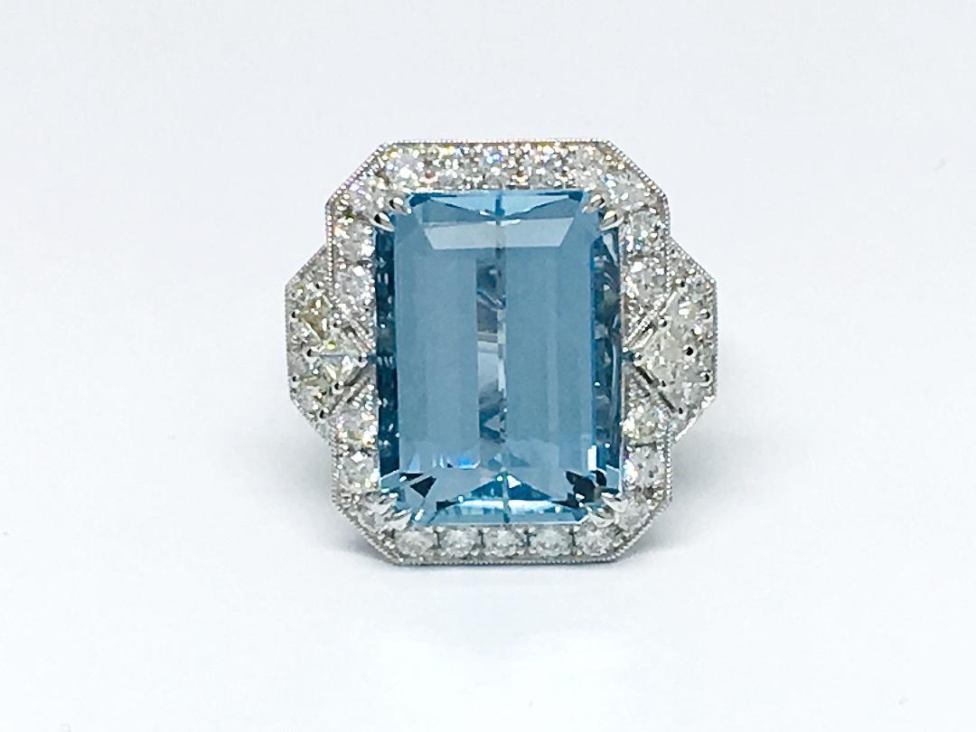 This beautiful piece is created with 
AQUAMARINE : 13.22 Total Carat Weight
52 Diamonds 1.25 Total Carat Weight
6 Diamonds 0.45 Total Carat Weight
F color , VS2 clarity setting on 
18k White Gold 5mm hand- engraving ring .
This ring is size  7, but