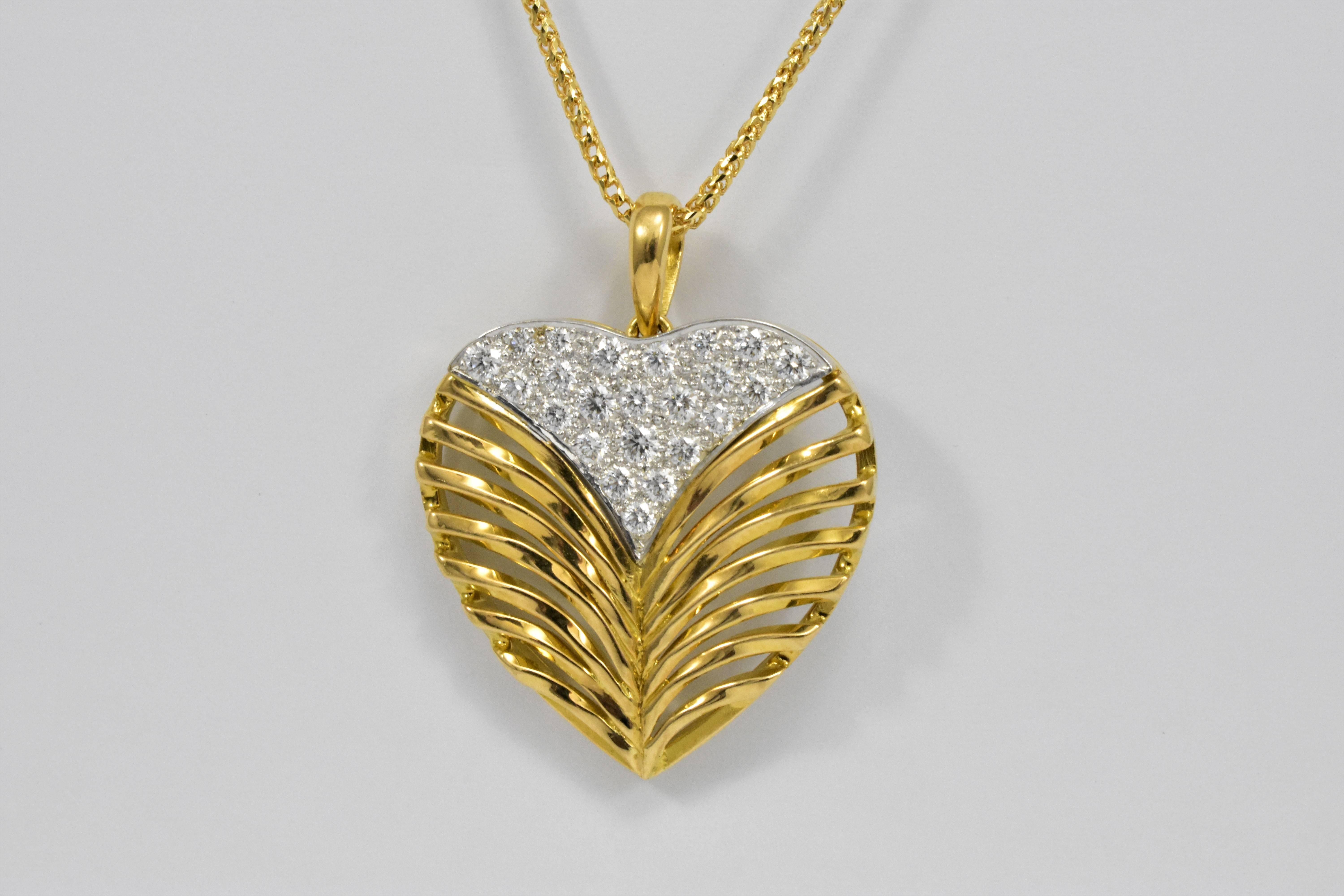 A very distinctive Daou design combining a white gold pavé diamond heart cleft with a sculptural highly polished yellow gold twisted branched leaf pattern. The heart pendant necklace in 18 karat yellow gold is set with round brilliant diamonds and