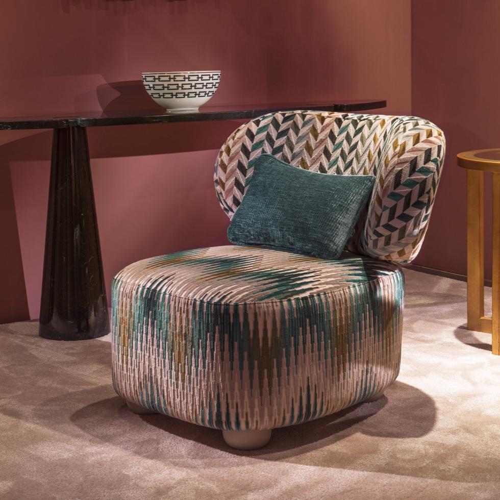 Part of Chiara Provasi's remarkable Daphne Collection, this stunning lounge chair conveys ultimate comfort and sophistication in its superb design and craftsmanship. Boasting a padded frame and a charming curved backrest, it is upholstered in a