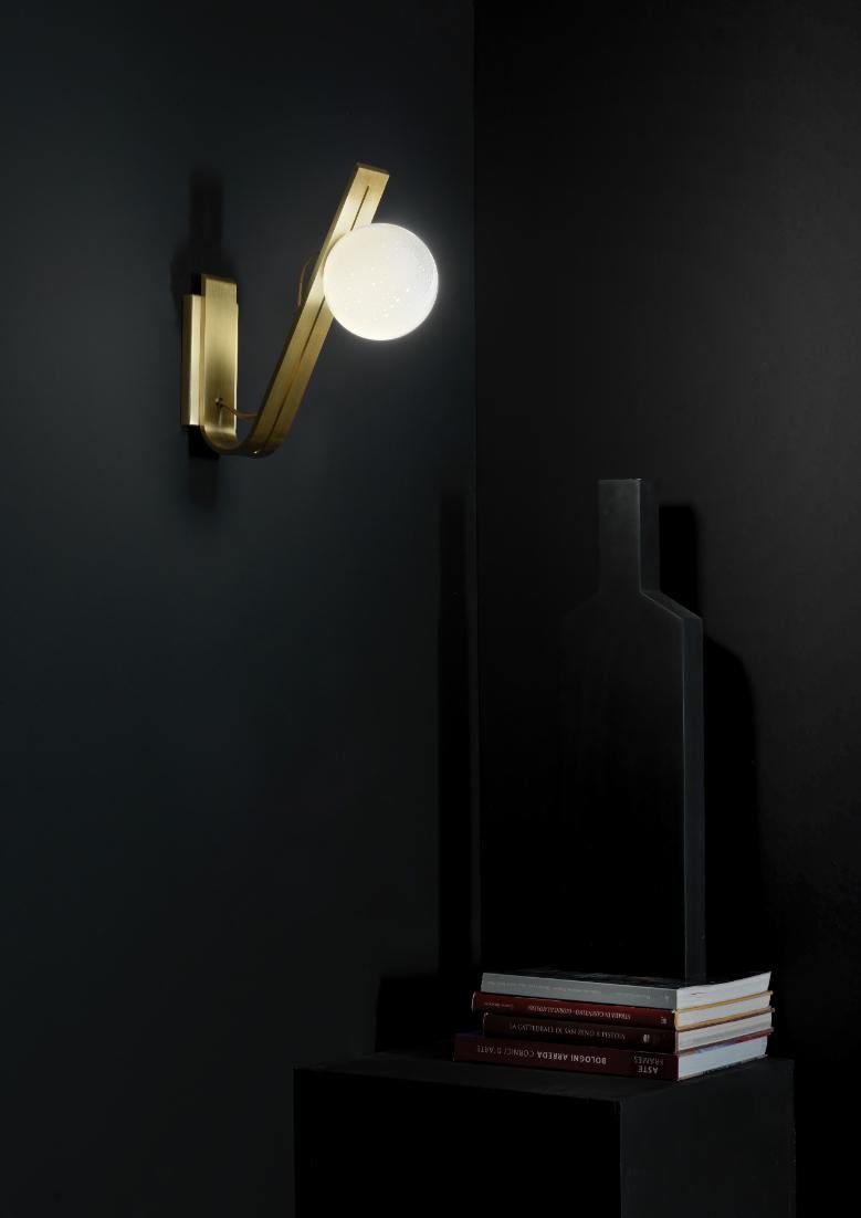 Daphne brass Italian sconce 
Daphne- Lamp made entirely of brass and glass with our “Pulegoso” effect. available in table, suspension, floor and wall version.
glass diameter - 14 cm (table and wall lamp) - 30 cm (suspension and floor