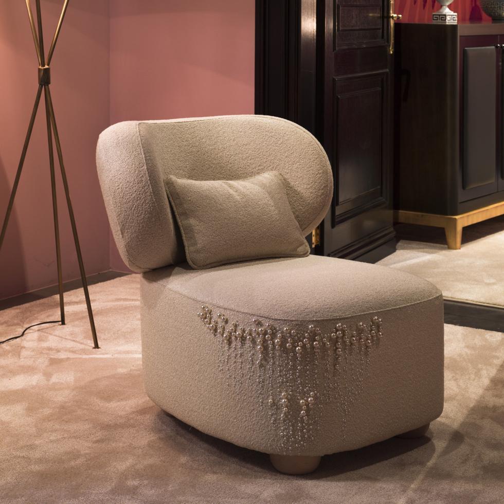 A luxurious lounge chair with a captivating allure for sophisticated living or bedroom interiors, the gorgeous Daphne Oyster flaunts a padded curved silhouette with a slightly reclined backrest for ultimate comfort. Superbly upholstered in refined