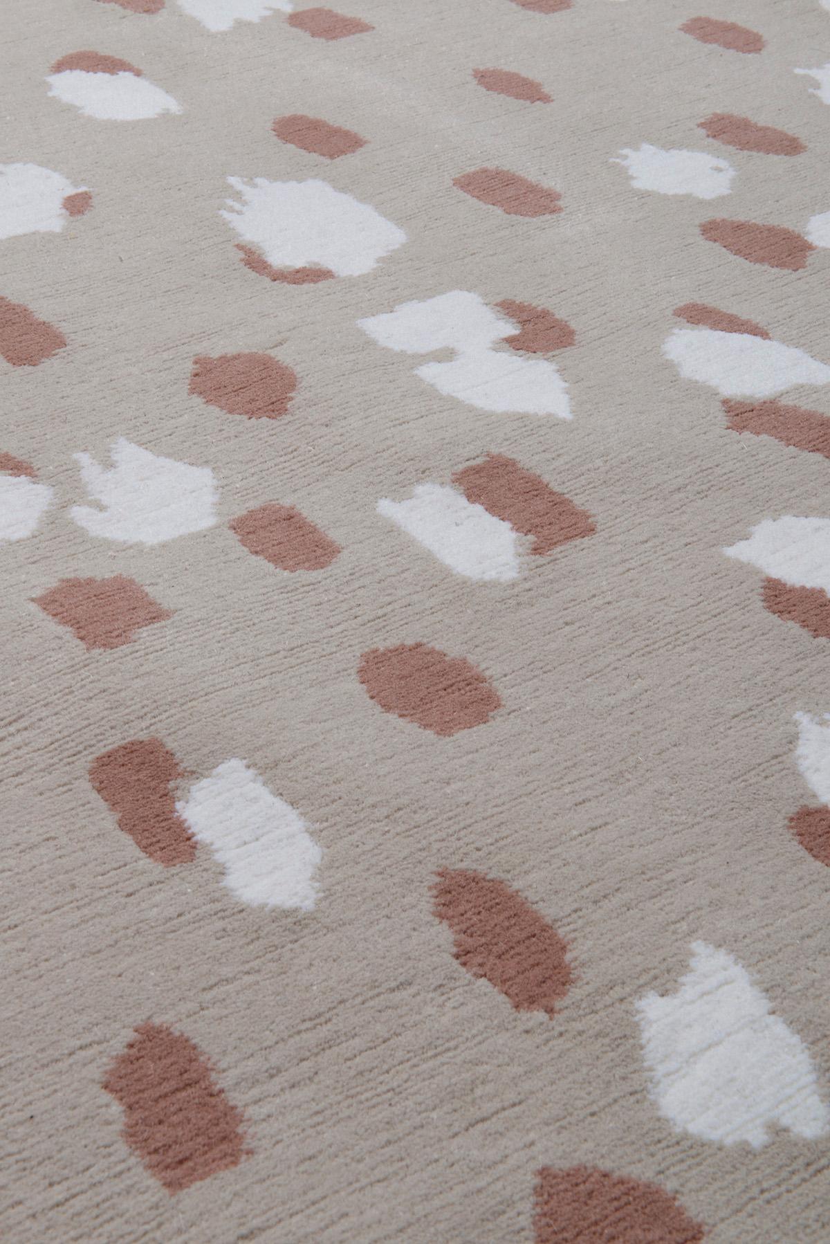 Dapple Rose rug features modest wool markings, which are orchestrated by colour into distinct sections of the rug. The composition of this design is concealed by a veil of identical markings, crafted in opposing techniques to subtly mask the