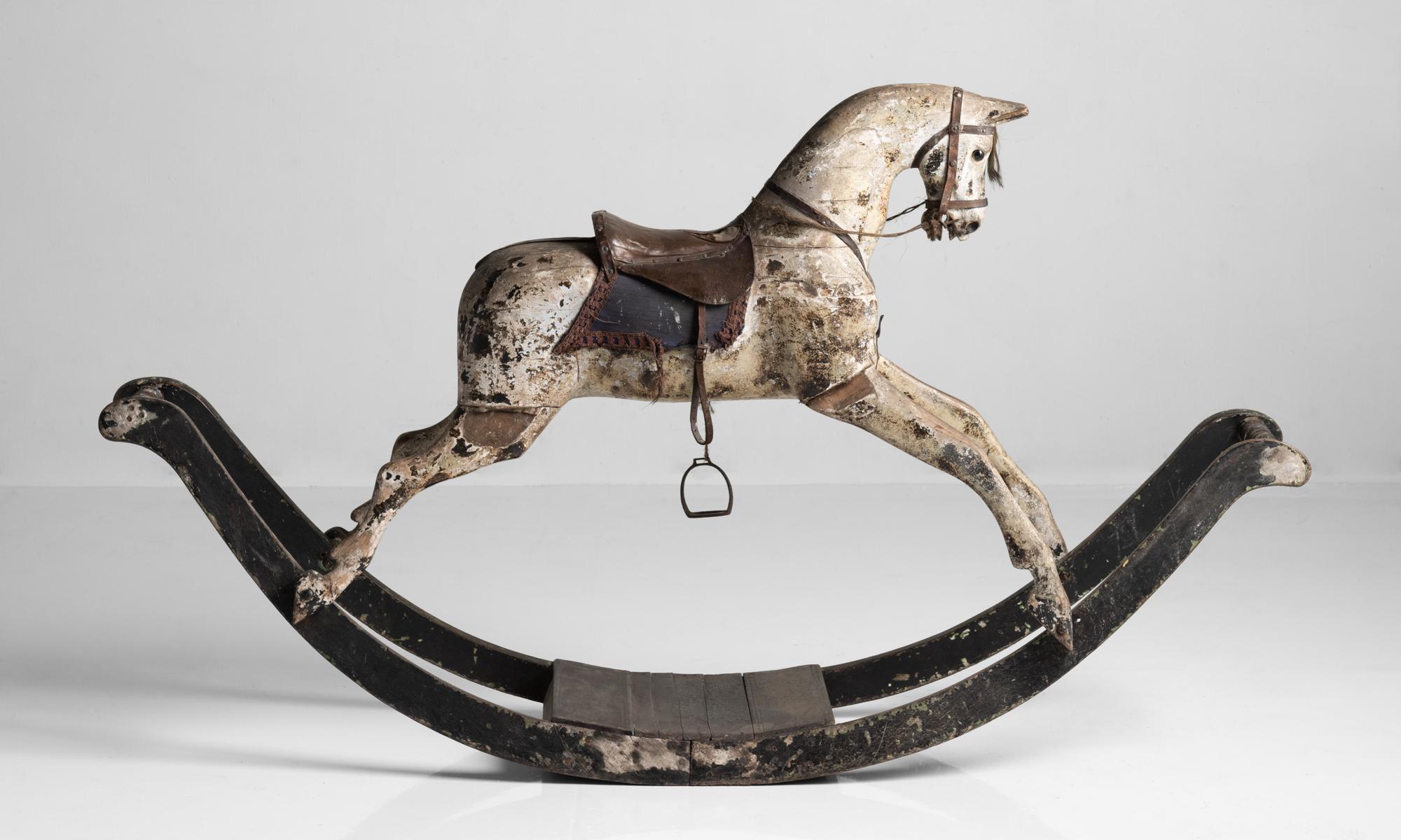 Dappled Grey Rocking Horse, England, circa 1820

On bow rocker at almost seven feet wide. Finely carved and painted by hand with original leather and embroidery saddle.