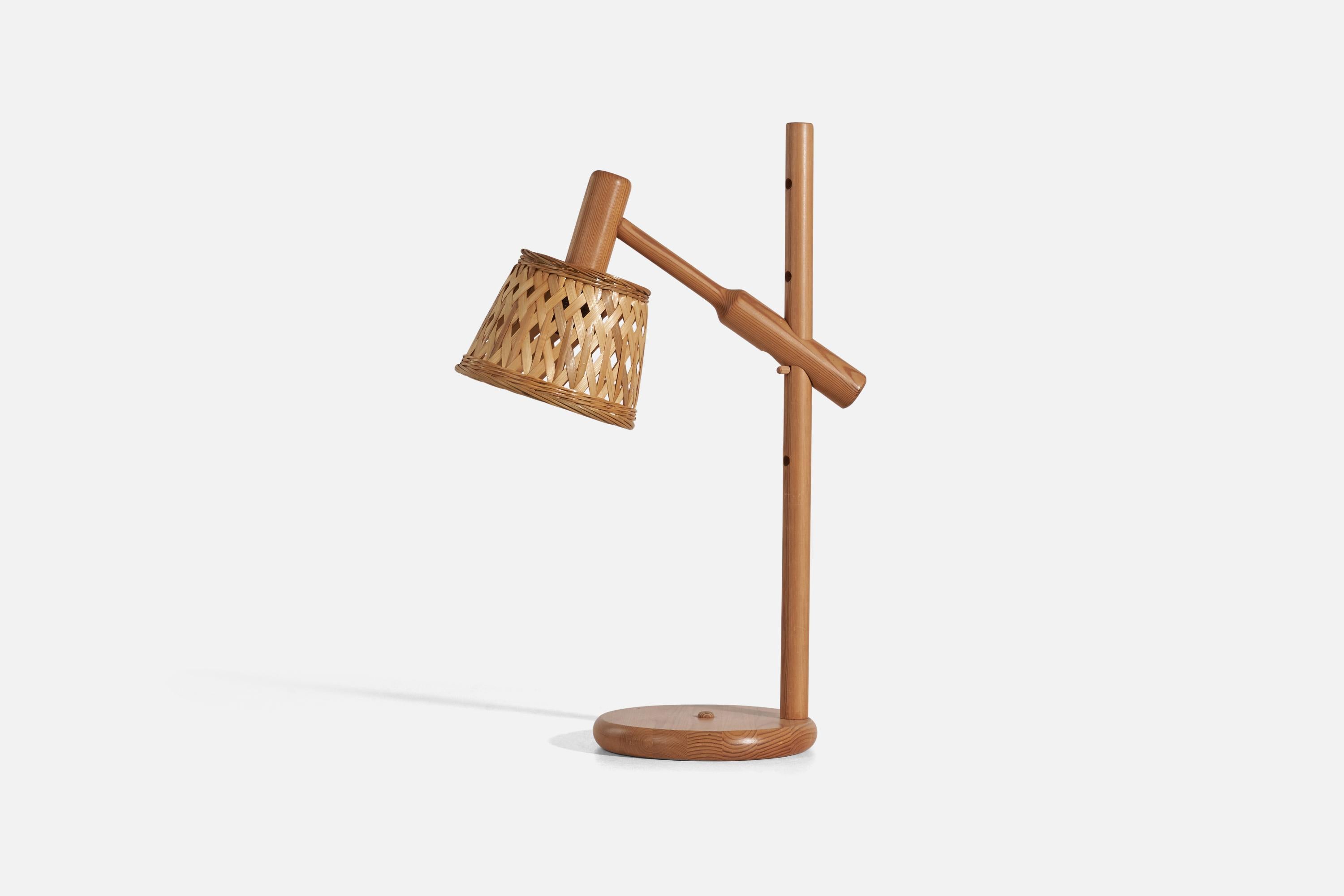 A pine and rattan table lamp designed and produced by Darø, Denmark, 1970s. 

Dimensions variable, measured as illustrated in first image.

Sold with Lampshade. Dimensions stated are of Table Lamp with Lampshade.

Socket takes standard E-26