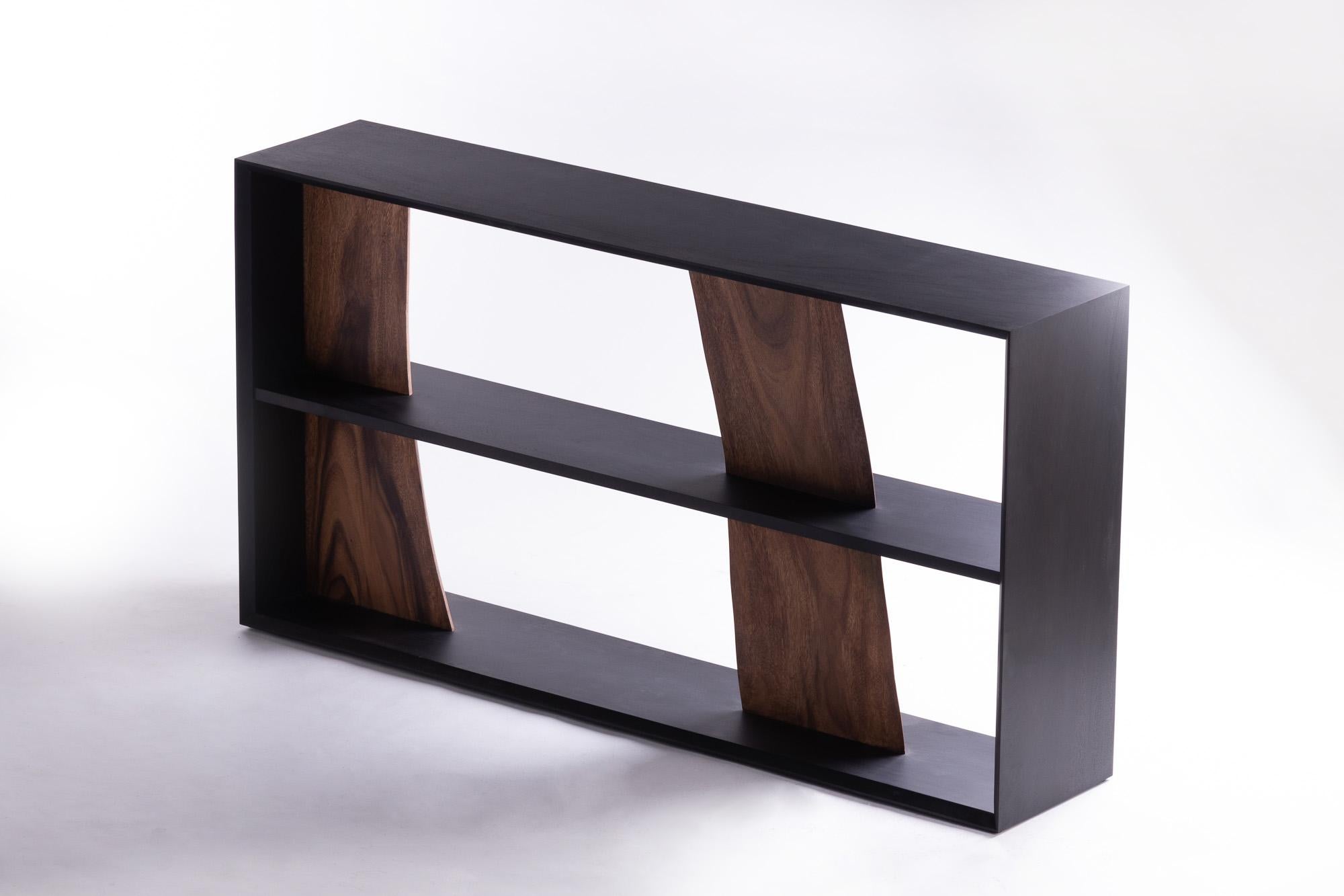 A great deal of time was spent considering the best way to cut wood without wasting its unique beauty. After careful consideration, this wood piece maintains its essential values by combining natural-shaped wood with simple pieces, creating a shelf