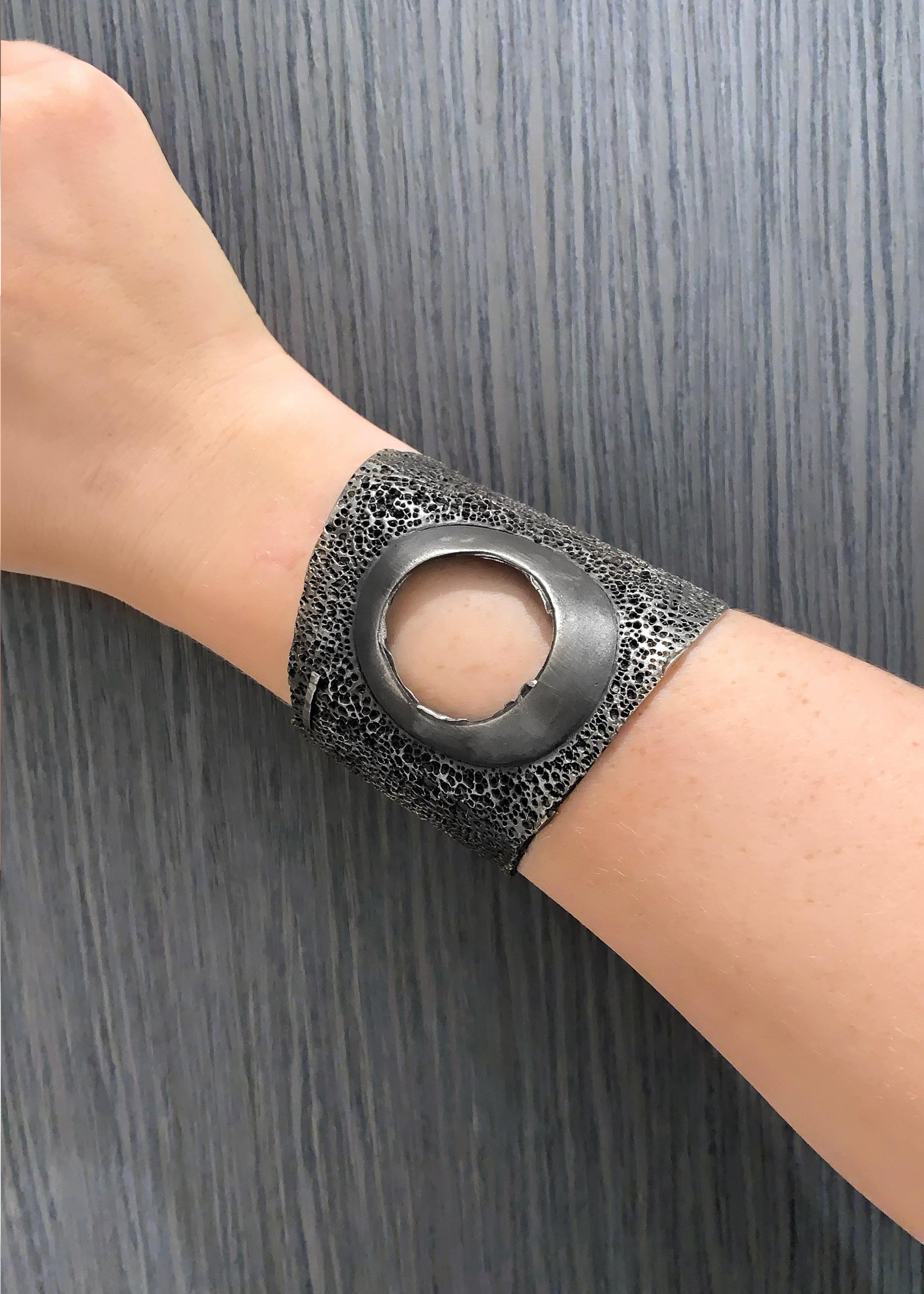 The One of a Kind Round Cut Cuff Bracelet is a wearable work of art, hand-fabricated by master metalsmith Darcy Miro in intricately textured oxidized sterling silver. Signed Darcy Miro 2008.

About the Maker - Darcy Miro, based out of Brooklyn, New
