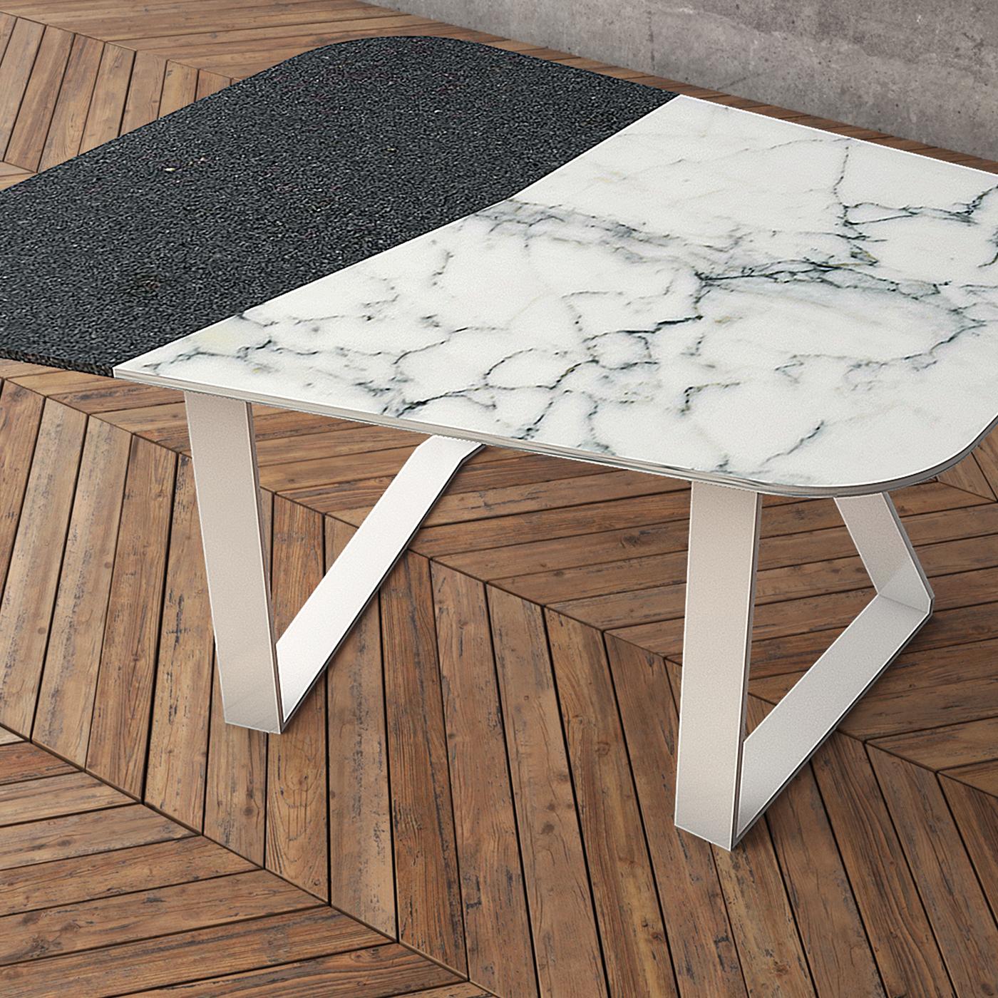 Functional and highly decorative, this coffee table combines two traditional Italian materials in a contemporary design of sleek and sophisticated allure. The top is in luxurious Carrara marble and lava stone sourced from the Sicilian volcano Etna,