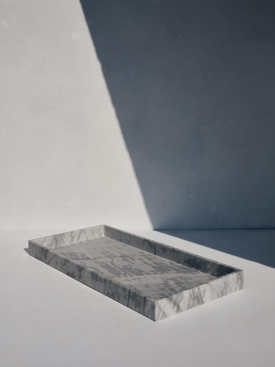 Dareios rectangular tray by Faye Tsakalides. 
Dimensions: 25.5 W x 54.5 L x 4.5 H cm
Materials: Special Gray Lais marble. 
Technique: Crafted from a single piece of marble. Hand-crafted, Polished. Mat finished. 

Faye Tsakalides is a Greek