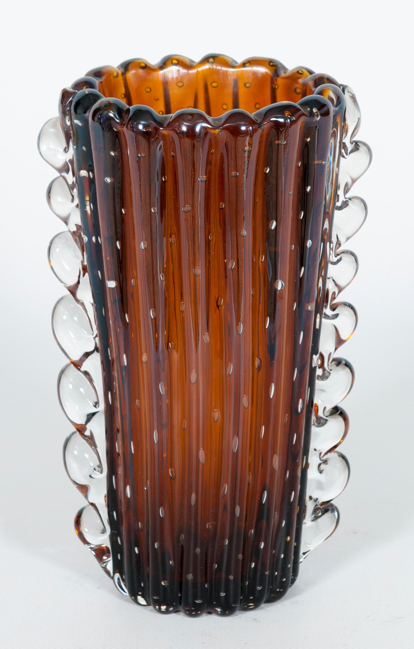 Dark-Amber Color Murano glass bubble vase with Morise Attributed to Seguso, 1980s, Italy.
This beautiful Venetian glass vase is made with blown dark-amber glass. The external surface is ribbed, decorated with vertical rounded stripes all around the