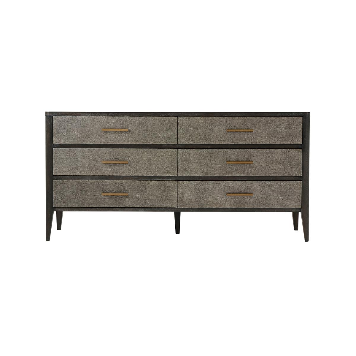 Leather Dresser in a dark rowan finish. The sides and the six drawers are wrapped in dark tempest finish Komodo embossed leather. With brushed brass finish hardware raised on flared tapering legs. 

Dimensions: 66.5