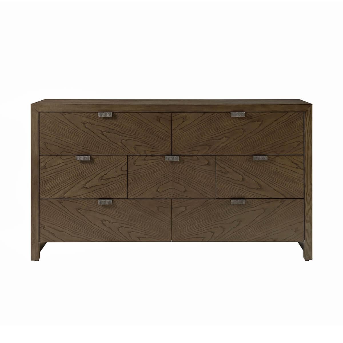 a sleek seven-drawer dresser made of figured cathedral ash in a dark Earth finish with textured metal pulls in our Ember finish and soft close drawers.

Dimensions: 64