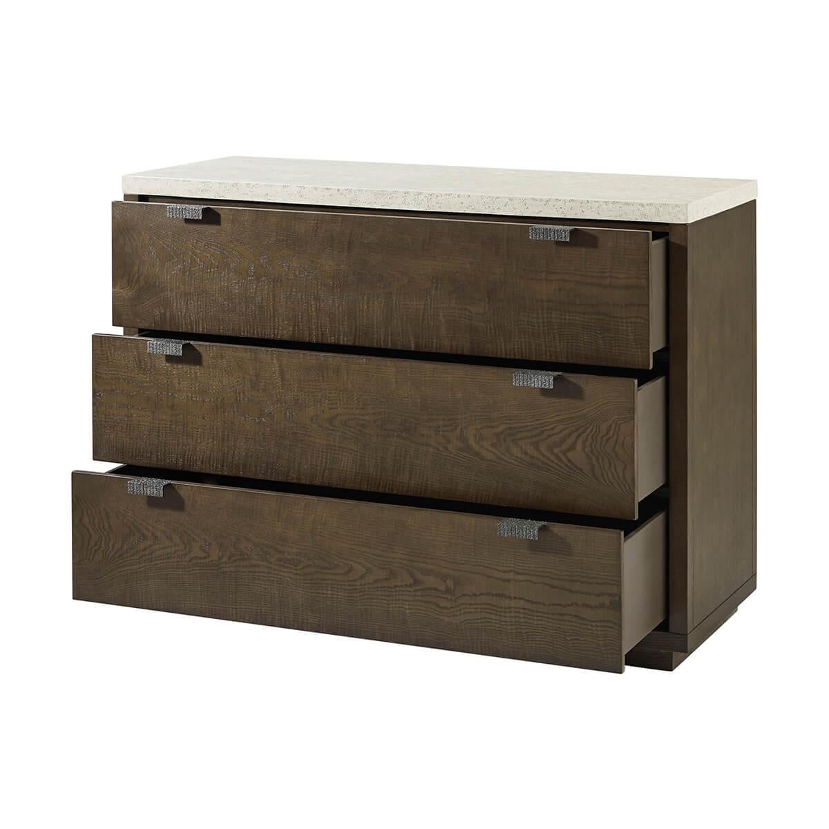Made of figured cathedral ash in an artful grain pattern with soft close drawers. Finished in a dark earth color with metal pulls in an Ember color. The top is done in an exclusive porous Mineral finish.

Dimensions: 50