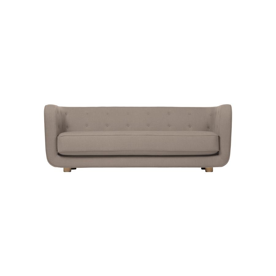 Dark beige and smoked oak Raf Simons Vidar 3 Vilhelm sofa by Lassen
Dimensions: W 217 x D 88 x H 80 cm 
Materials: Textile, Oak.

Vilhelm is a beautiful padded three-seater sofa designed by Flemming Lassen in 1935. A sofa must be able to