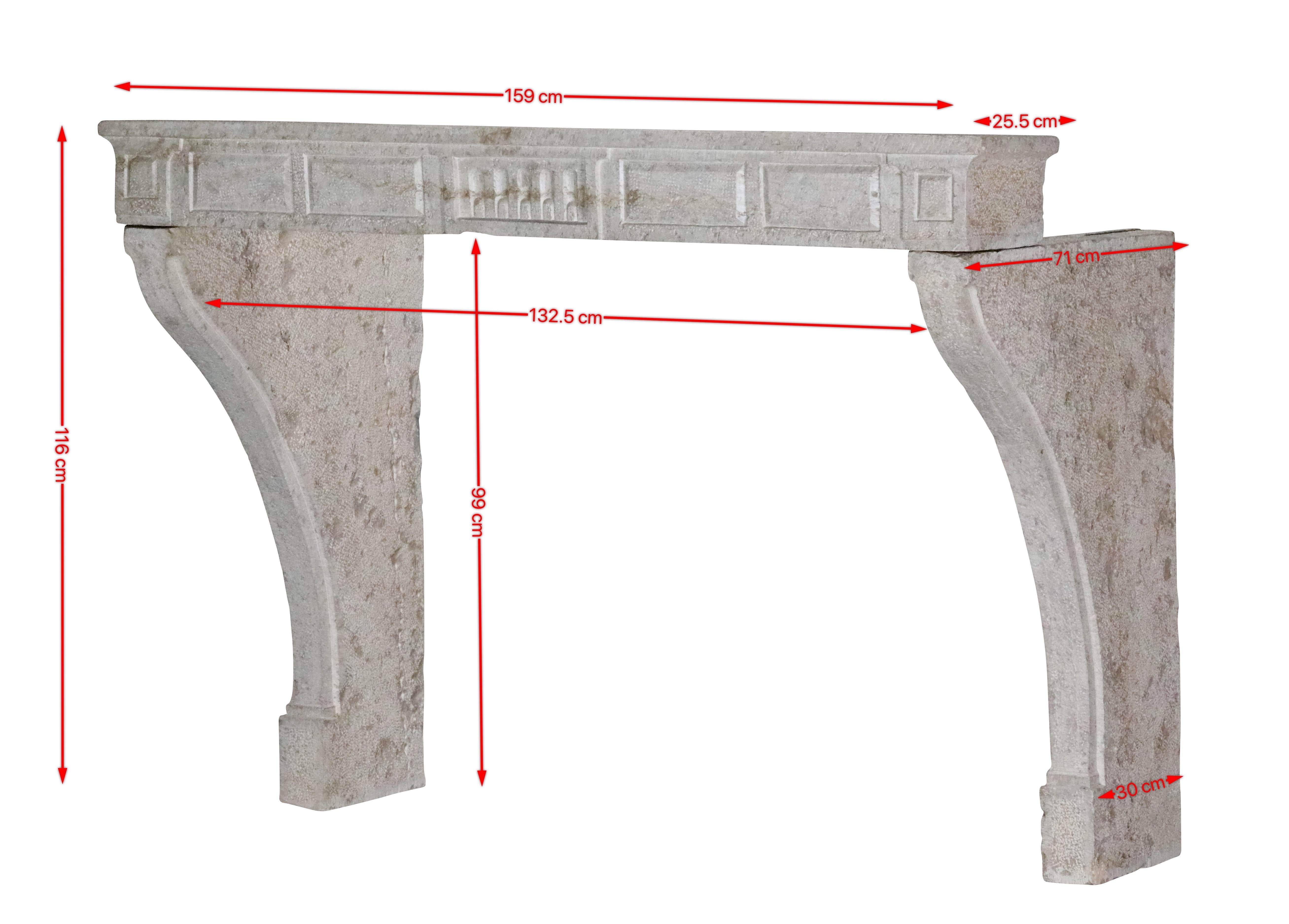 18th century French timeless rustic fireplace surround in hard limestone. Exceptional carving details. This authentic decorative piece projects everyone straight to France. 
Measurements:
159 cm Exterior Width 62,60 Inch
116 cm Exterior Height 45,67